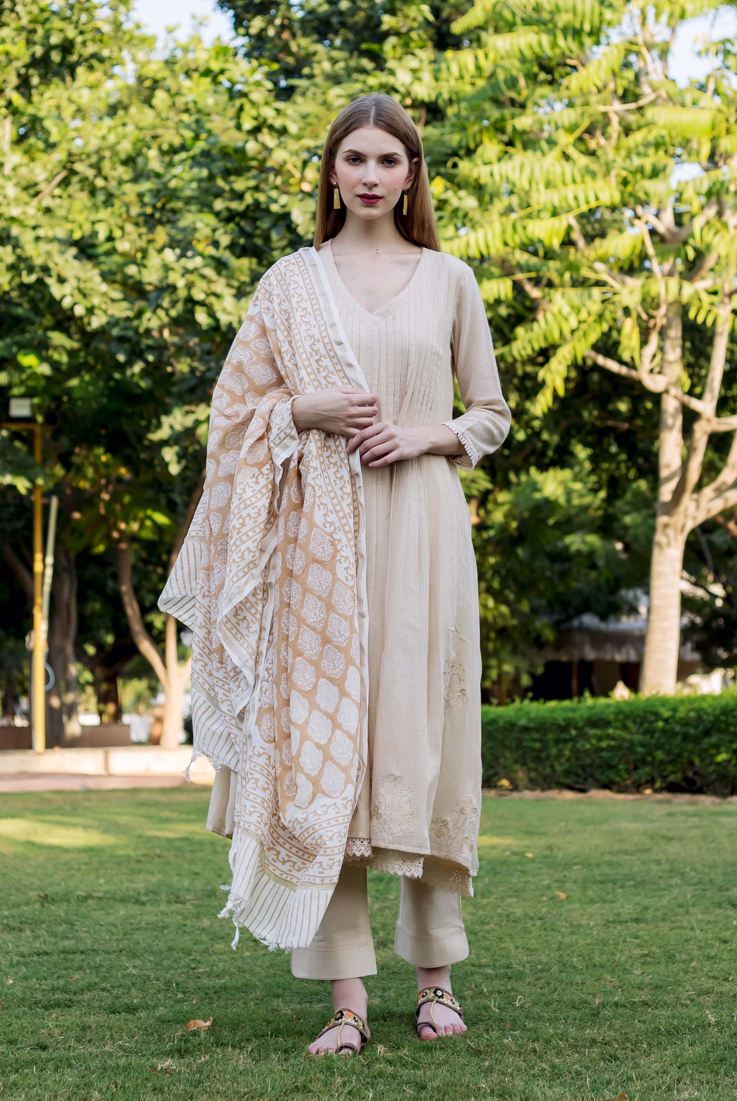 Full-length model in beige embroidered kurta set with misprint hand-block-printed ethnic dupatta.