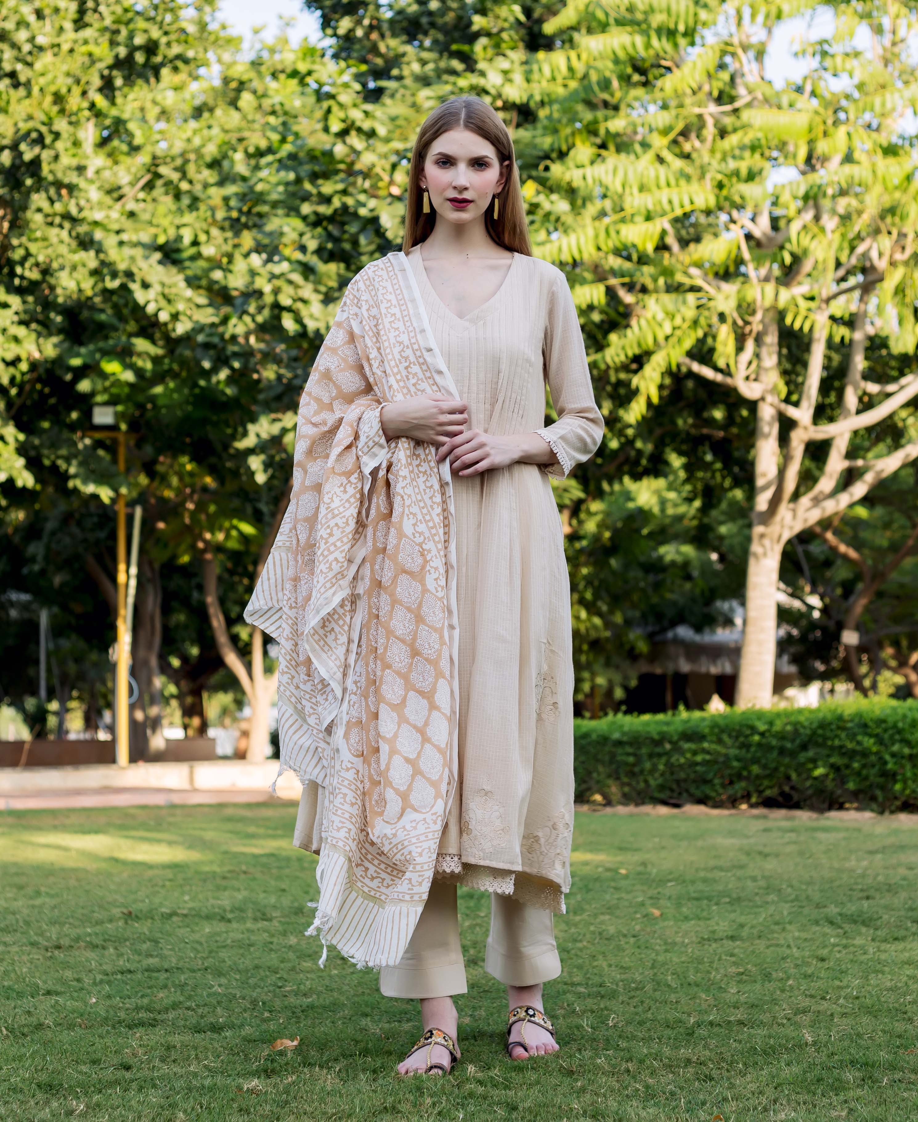 Full-length model in beige embroidered kurta set with misprint hand-block-printed ethnic dupatta.