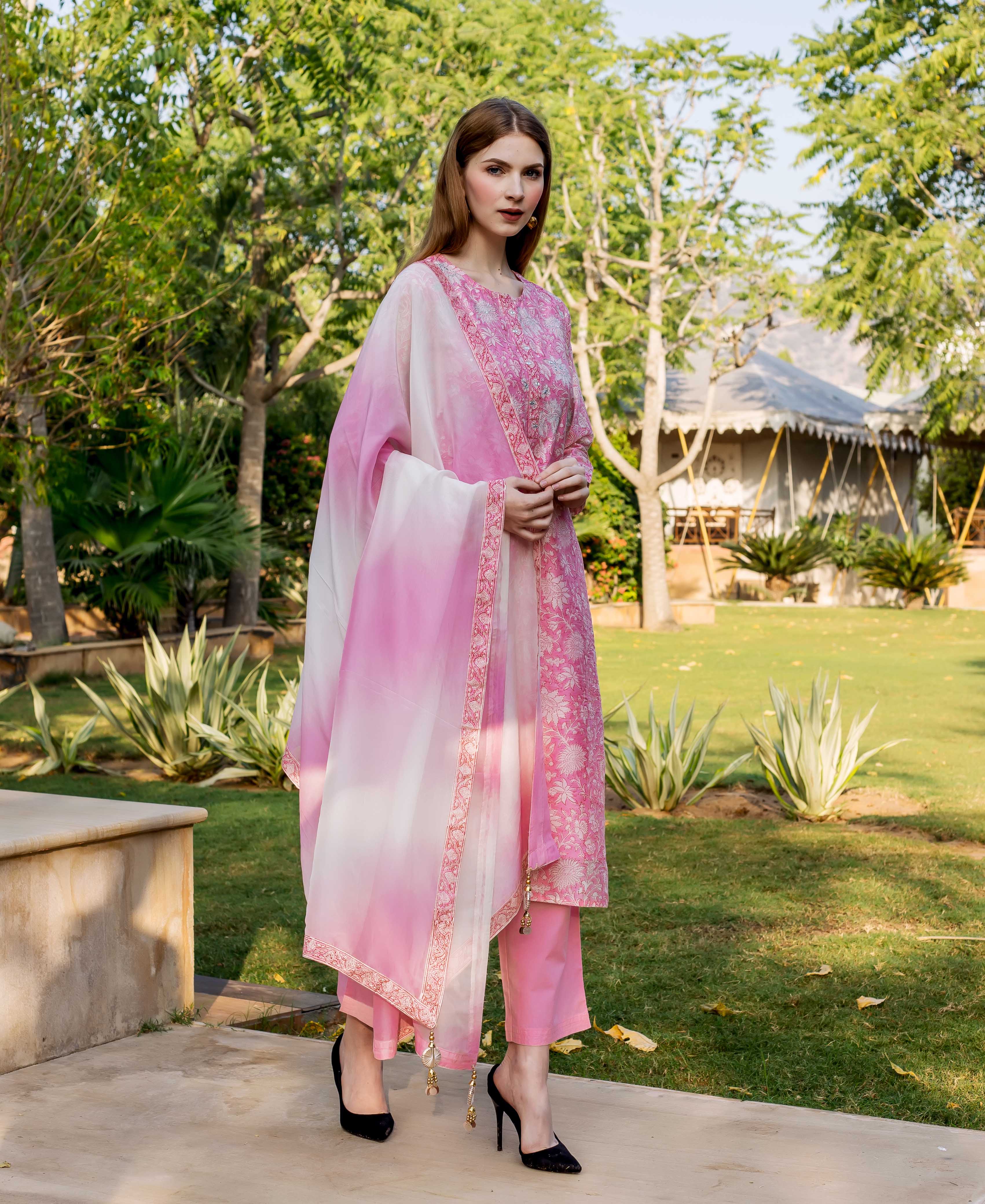 Full-length model wears pink hand-block printed and embroidered kurta set with ombre dupatta.