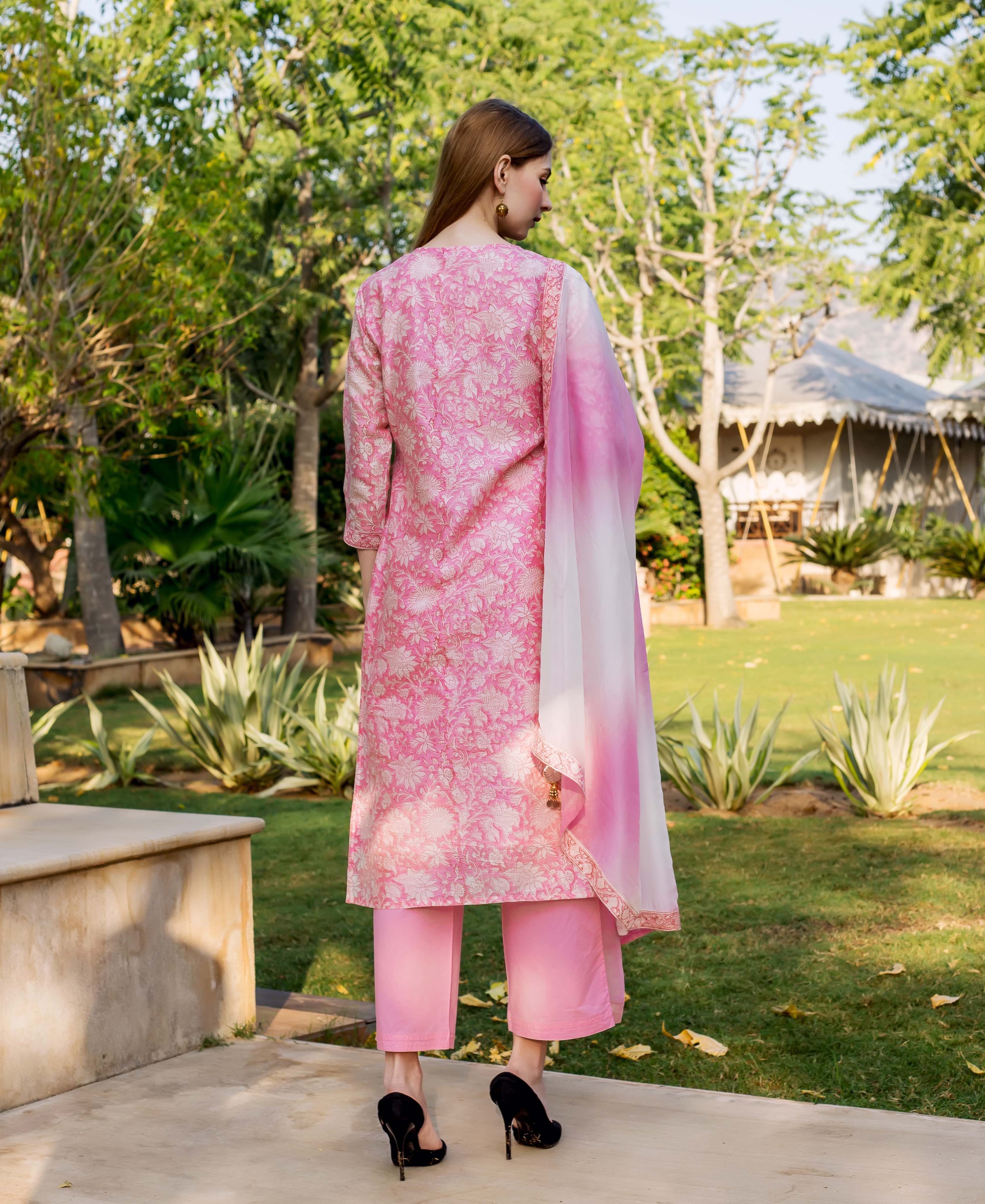 Back view of model wearing pink hand block printed kurta, matching pants, and ombré dupatta.