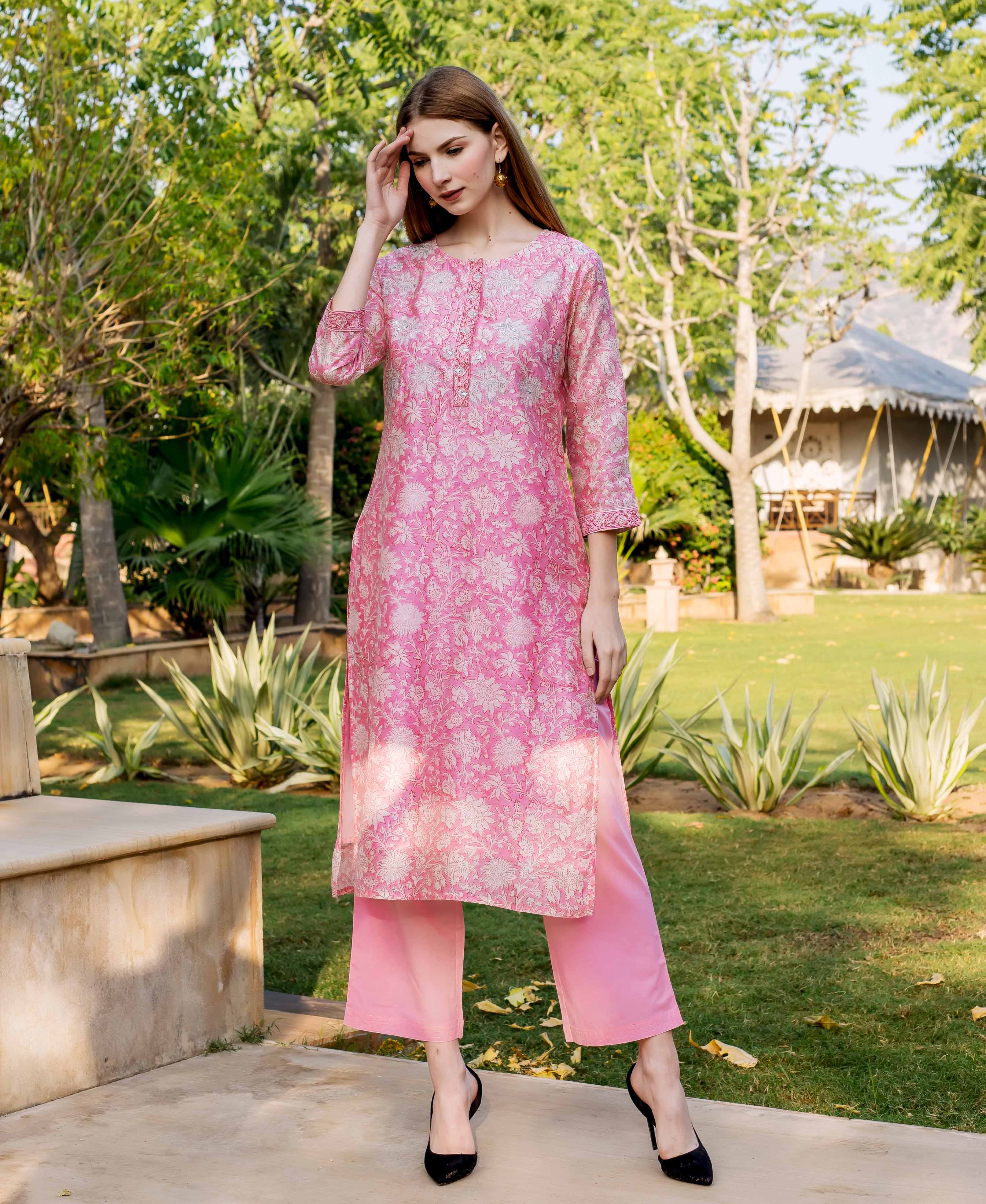Full-length model in pink hand-block printed floral kurta with subtle embroidered details.