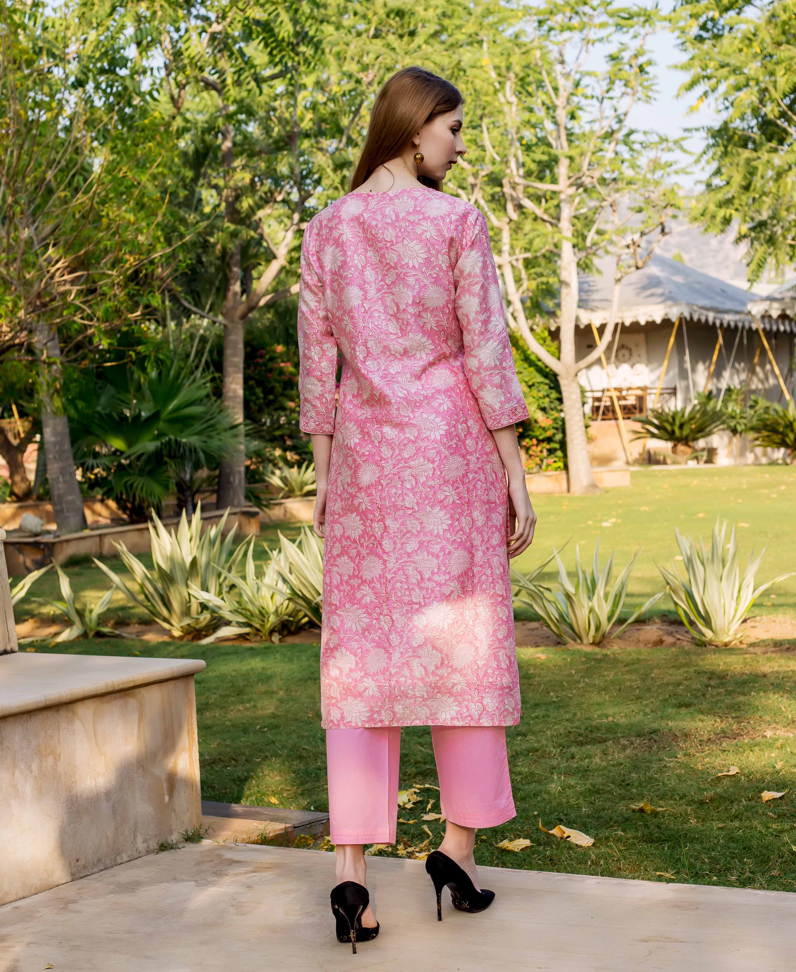 Model from back wearing a pink floral hand block printed kurta and matching pants.
