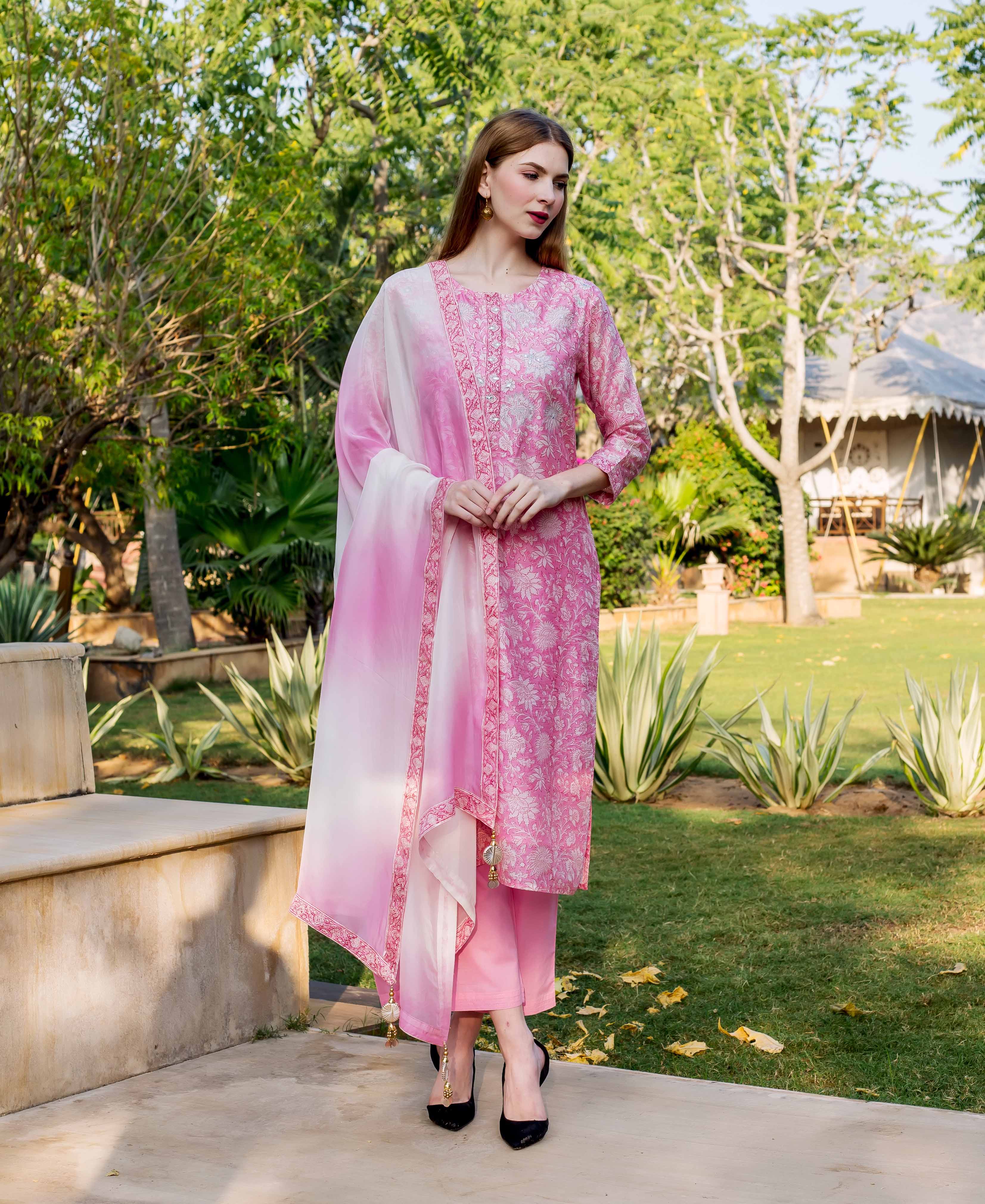 Full-length model in pink hand block printed and embroidered kurta set with ombré dupatta.