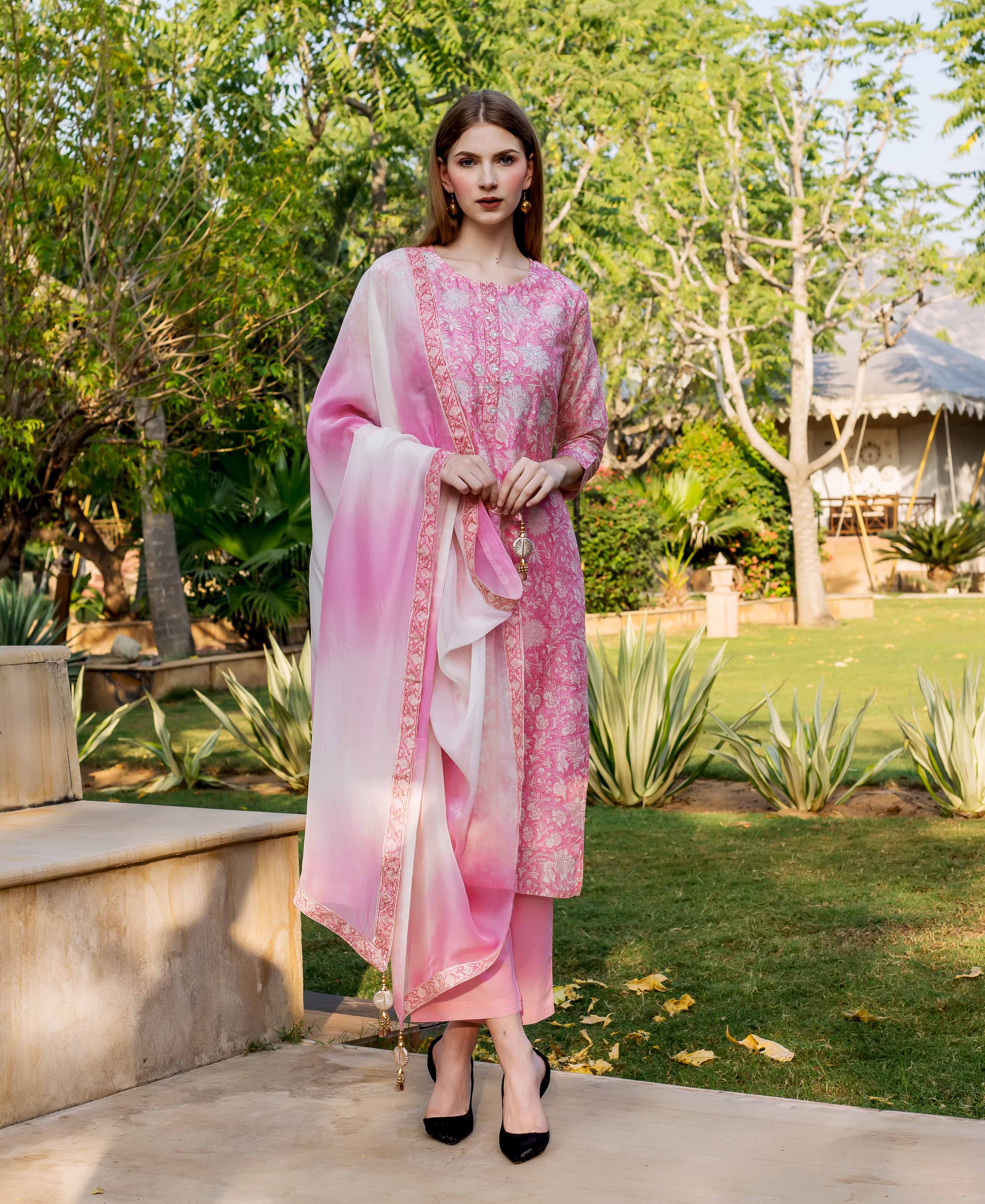 Full shot of model in pink hand block printed and embroidered kurta set, ombre dupatta.