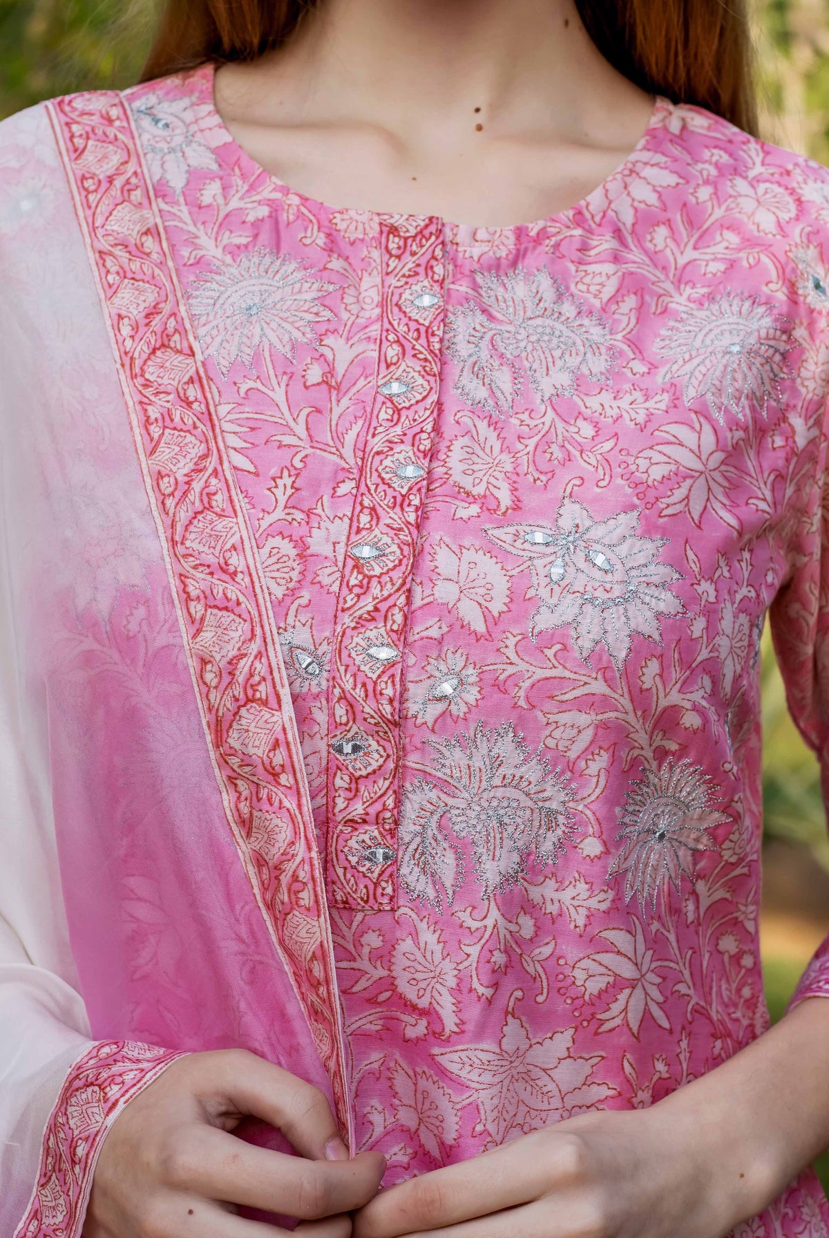 Pink kurta with white floral patterned hand block print and silver embroidery details visible.