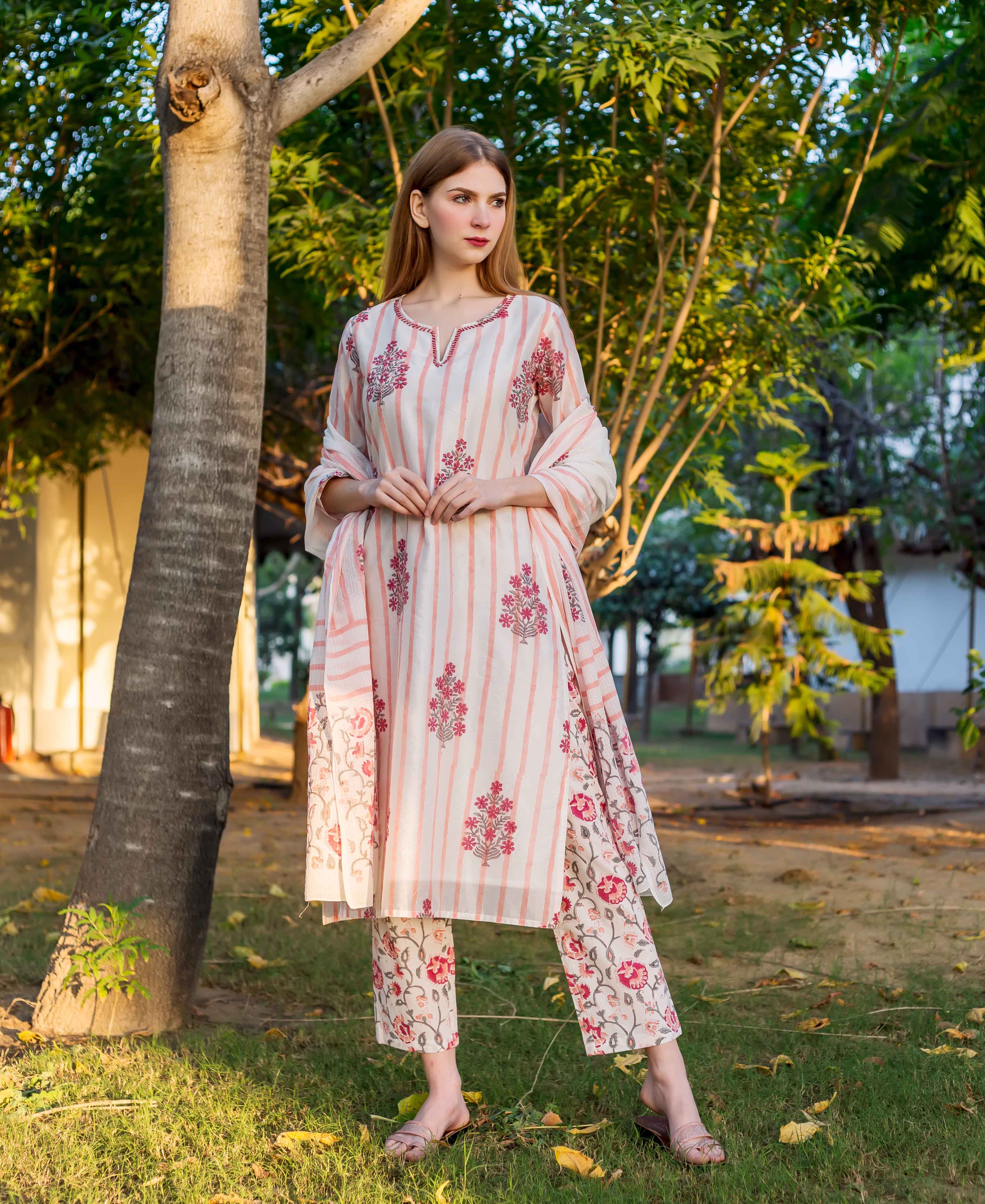 A model wearing a white and pink striped kurta with floral prints.