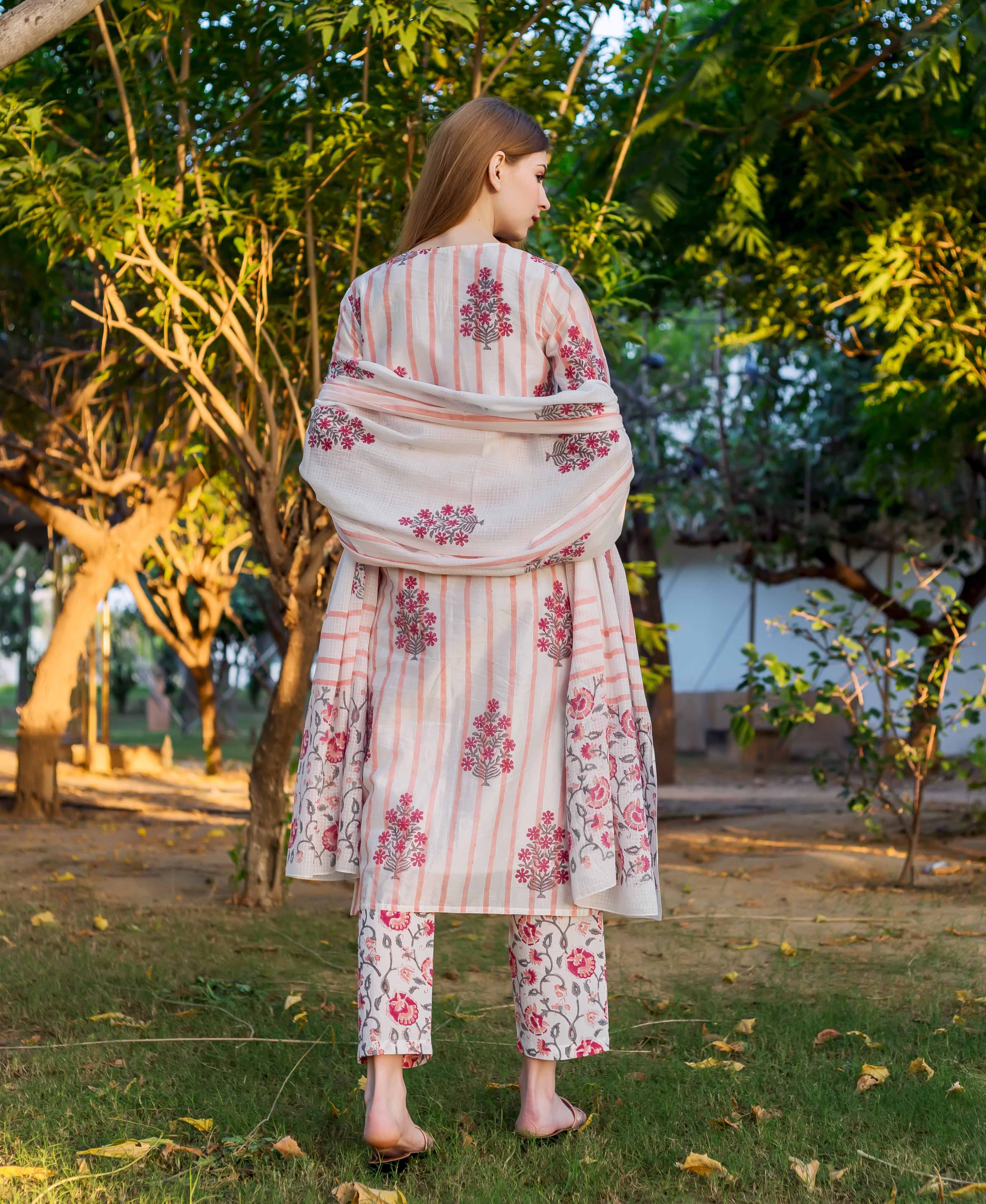 A model wearing a white and pink floral printed kurta with a matching dupatta.