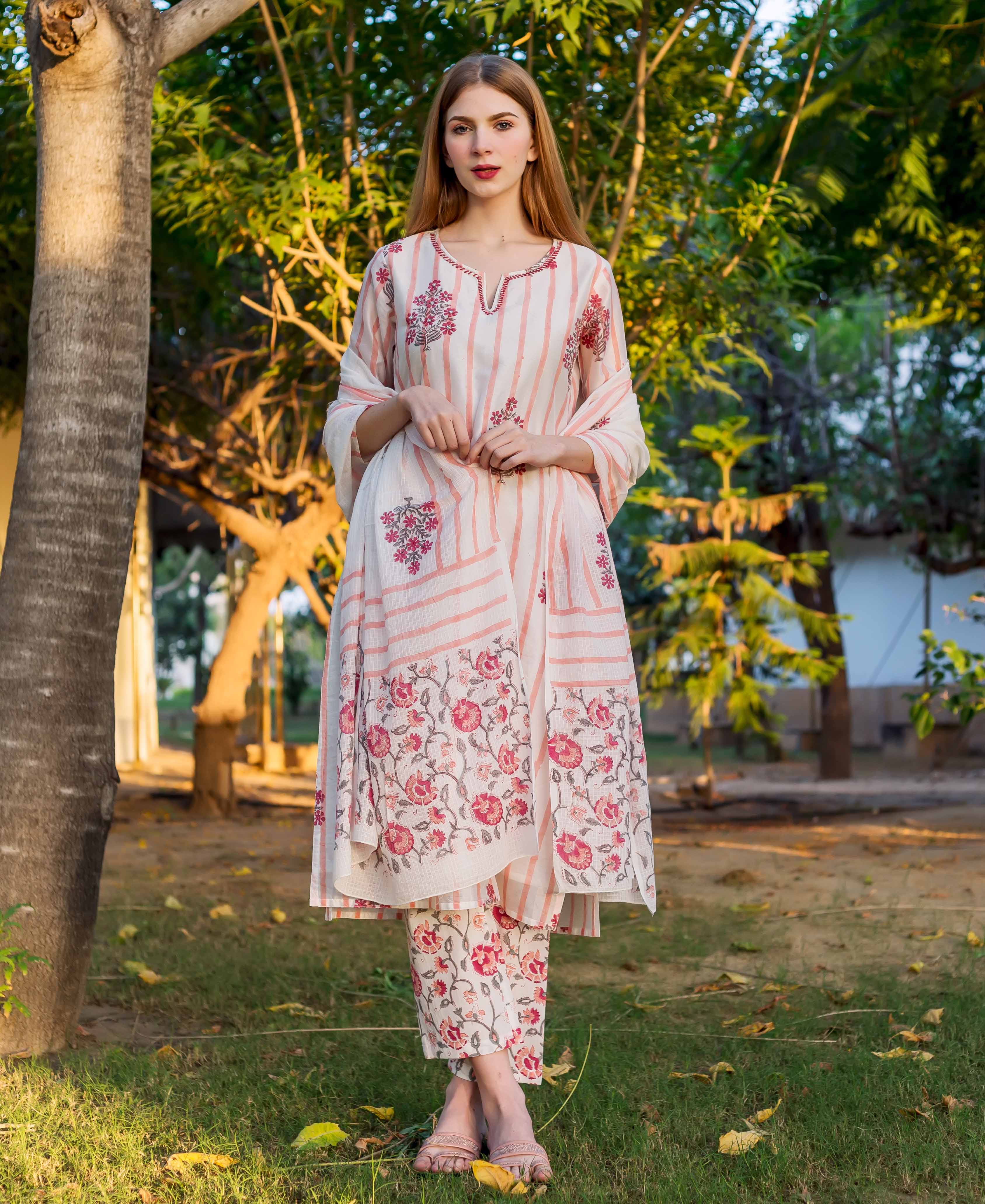A model wearing a white and pink striped kurta with floral print.