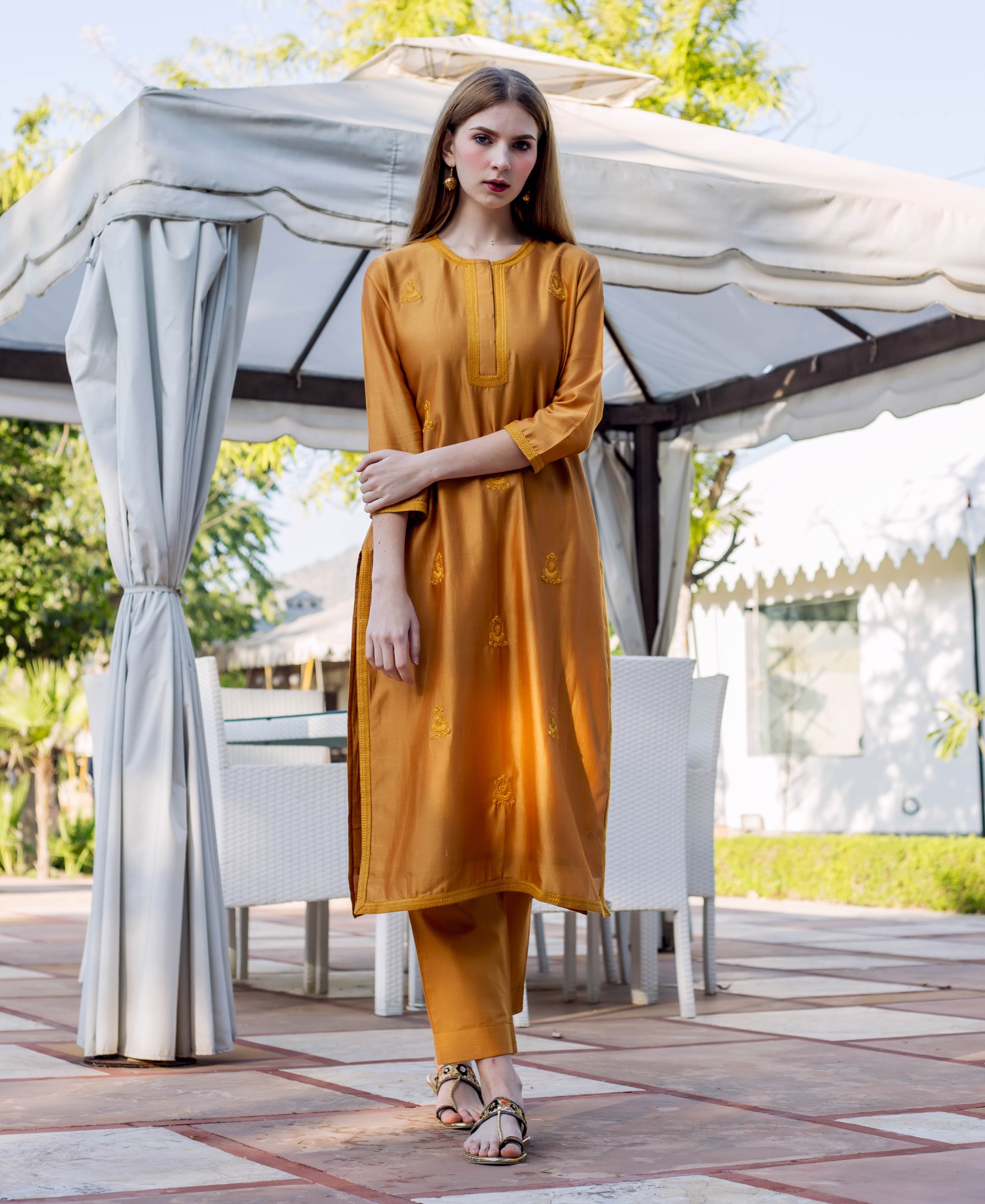 Front view full-look of model wearing an Autumn Rust embroidered kurta with matching pants.