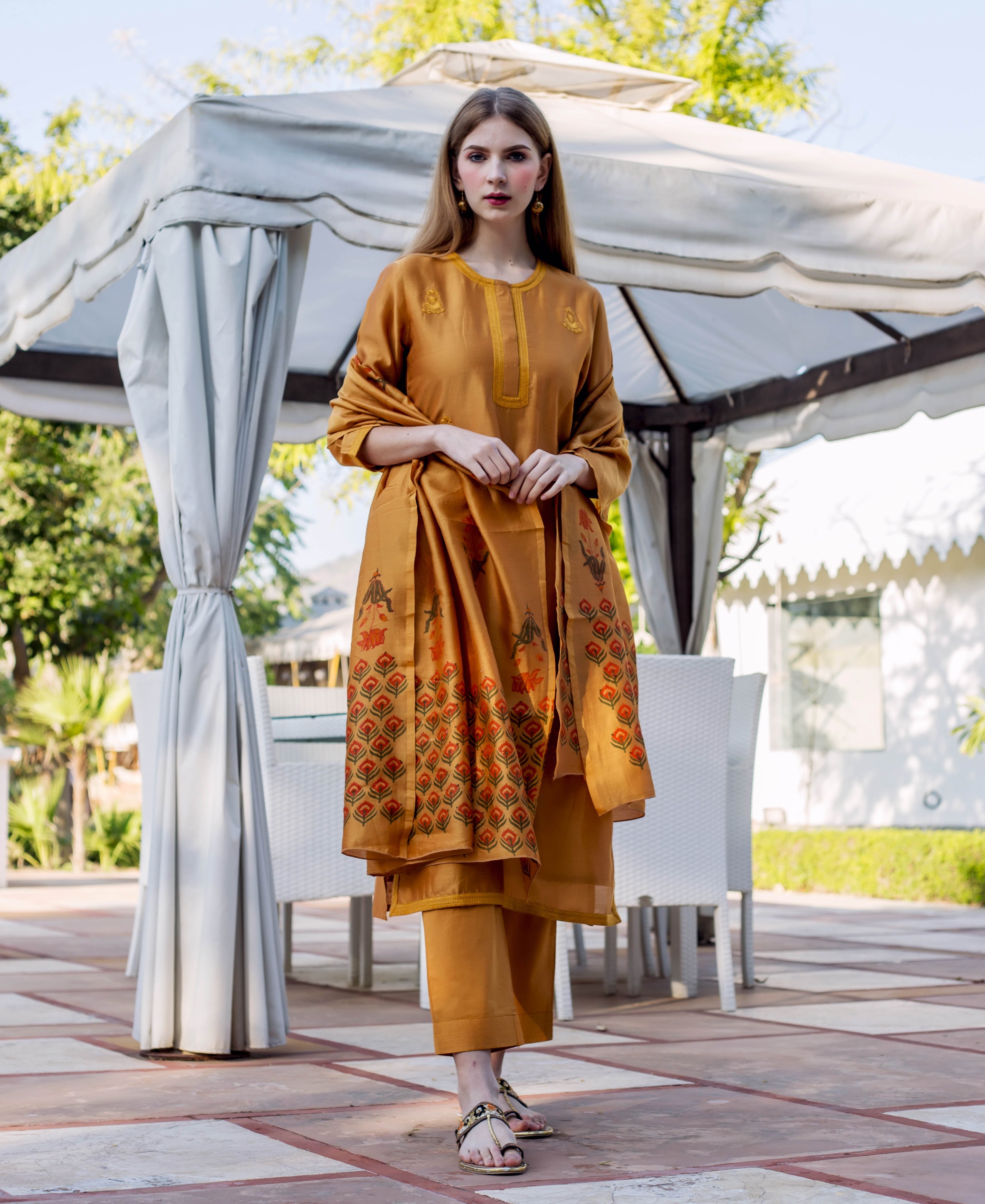 Model in Autumn Rust hand-block-printed kurta set with patterned dupatta and straight trousers, front view.