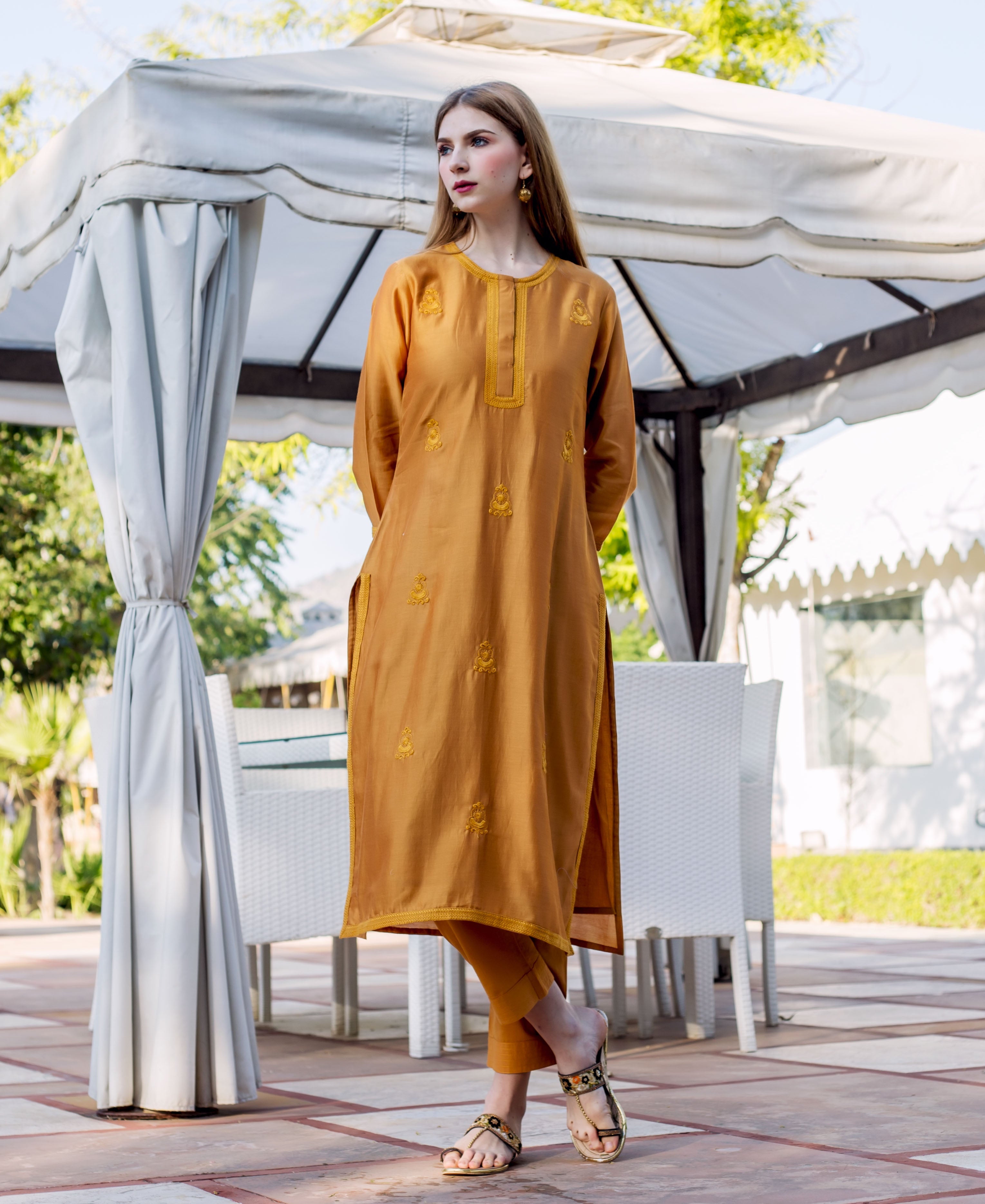 Front full-look of model wearing autumn rust embroidered kurta with matching pants.
