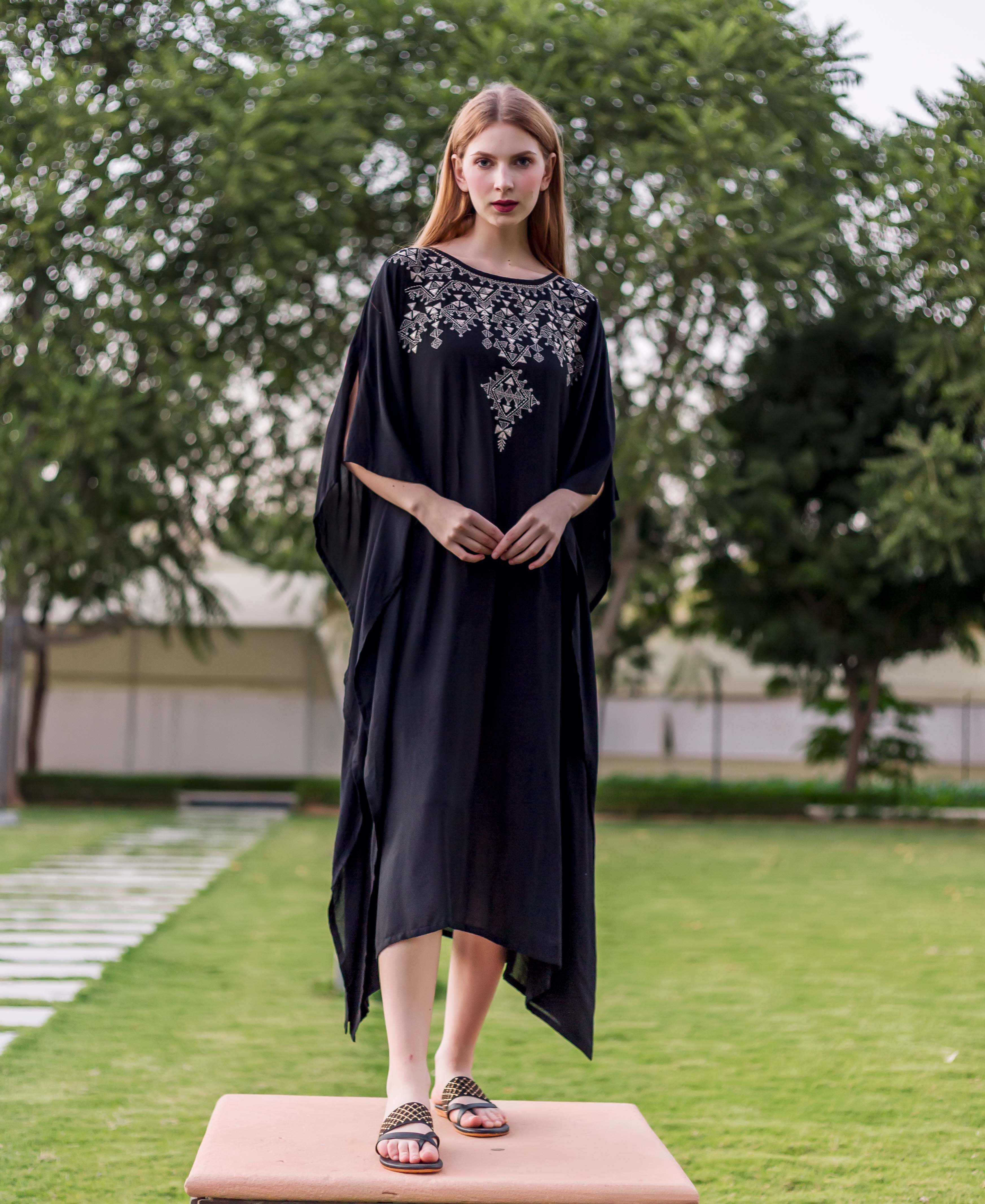 Black muslin embroidered kaftan on model, front view, with silver geometric chest embroidery.