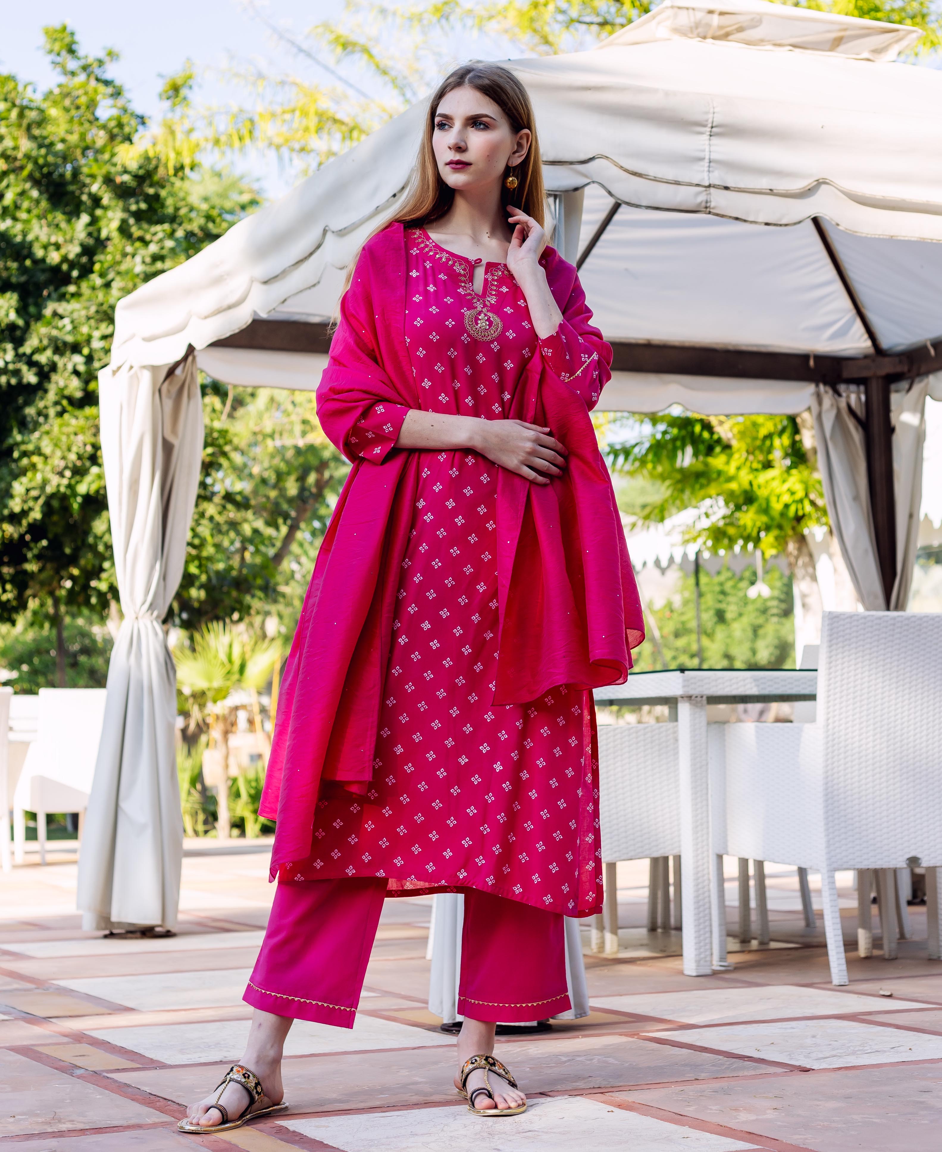 Full-length model in a magenta embroidered kurta set with Bandhej print and matching dupatta.
