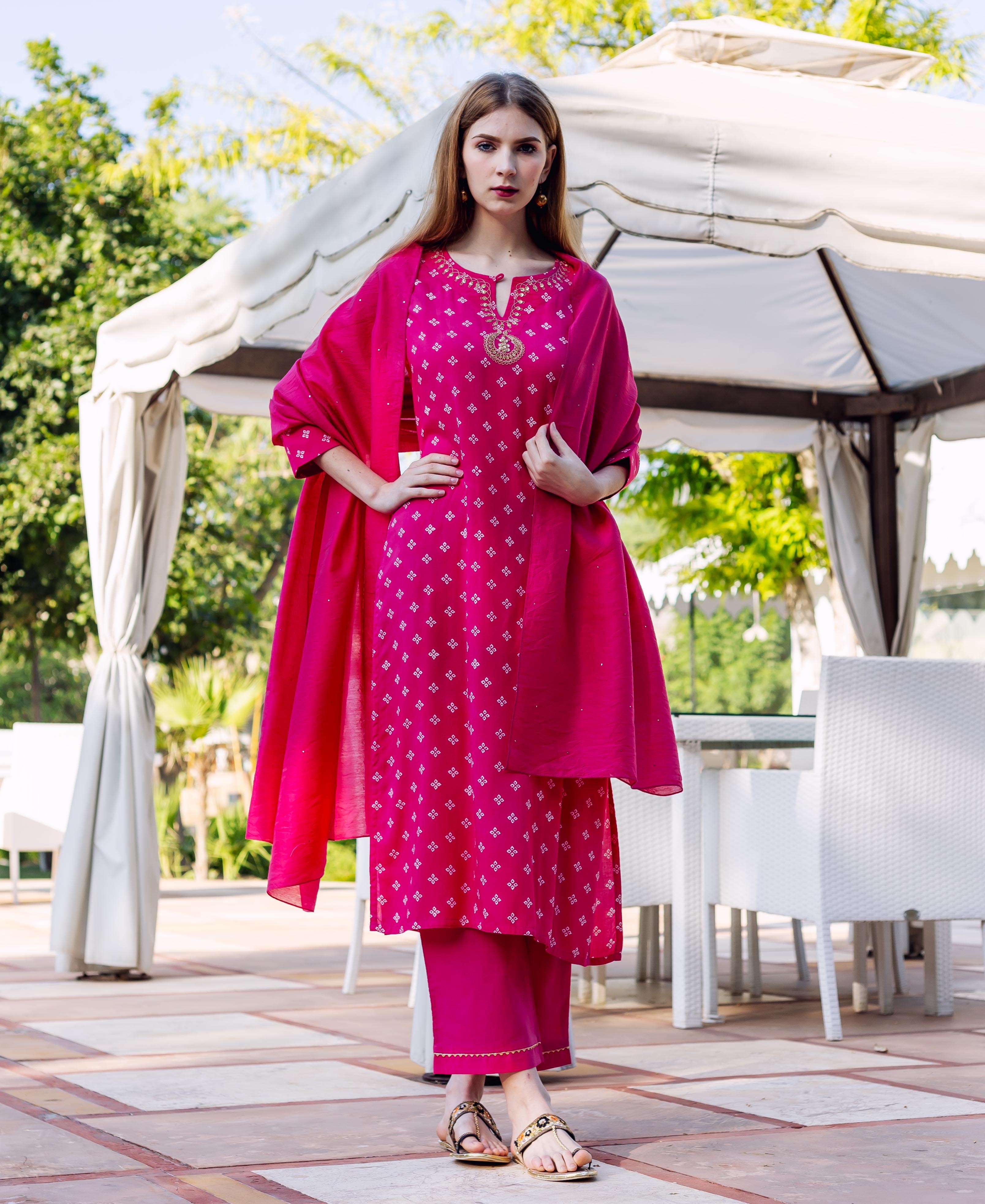 Full-length model in magenta bandhej printed kurta set with embroidered neckline and dupatta.