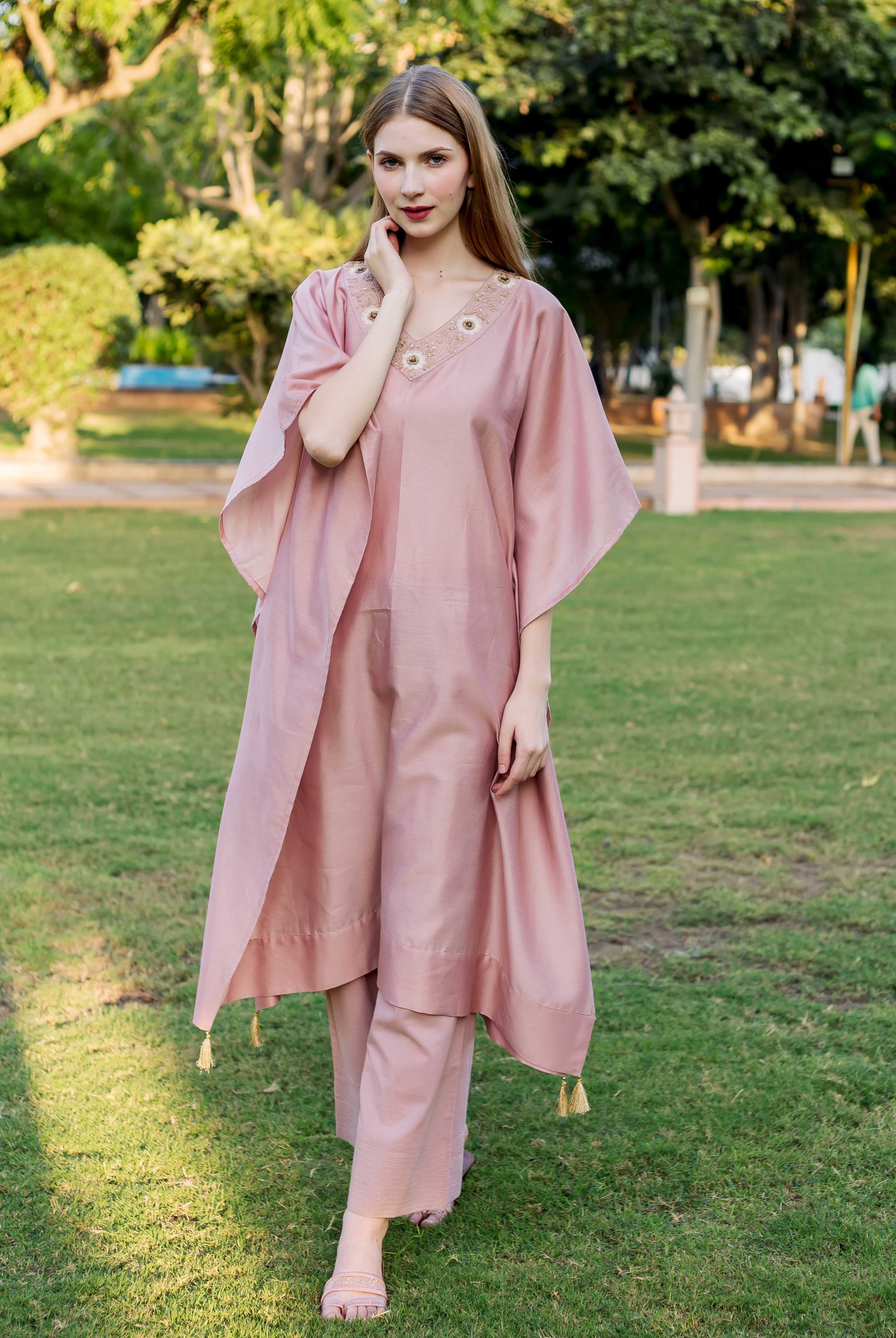 Dusty pink hand-embroidered V-neck kaftan with matching trousers worn by a model.