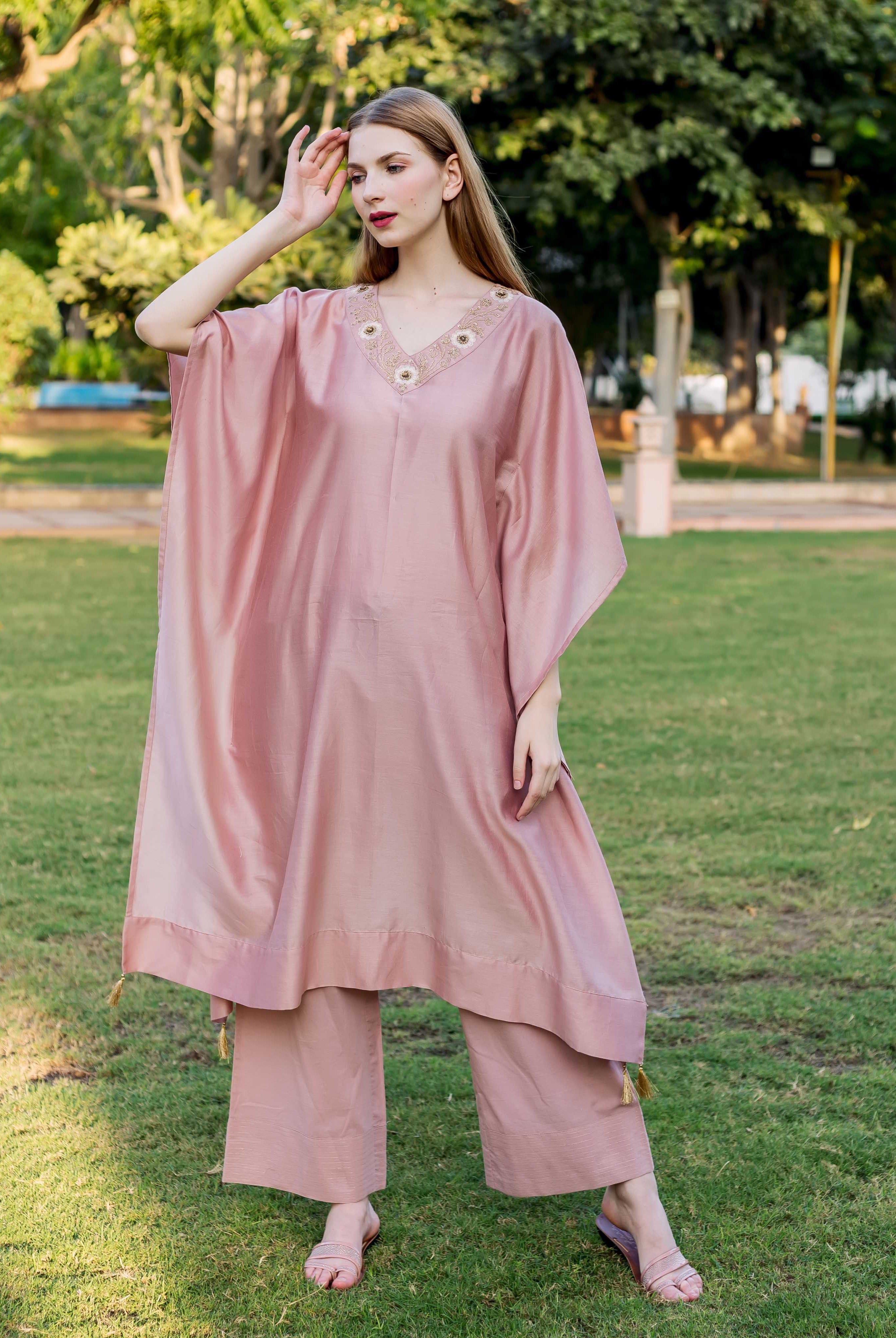 Front view of model in dusty pink kaftan with hand-embroidered V-neck and matching pants.