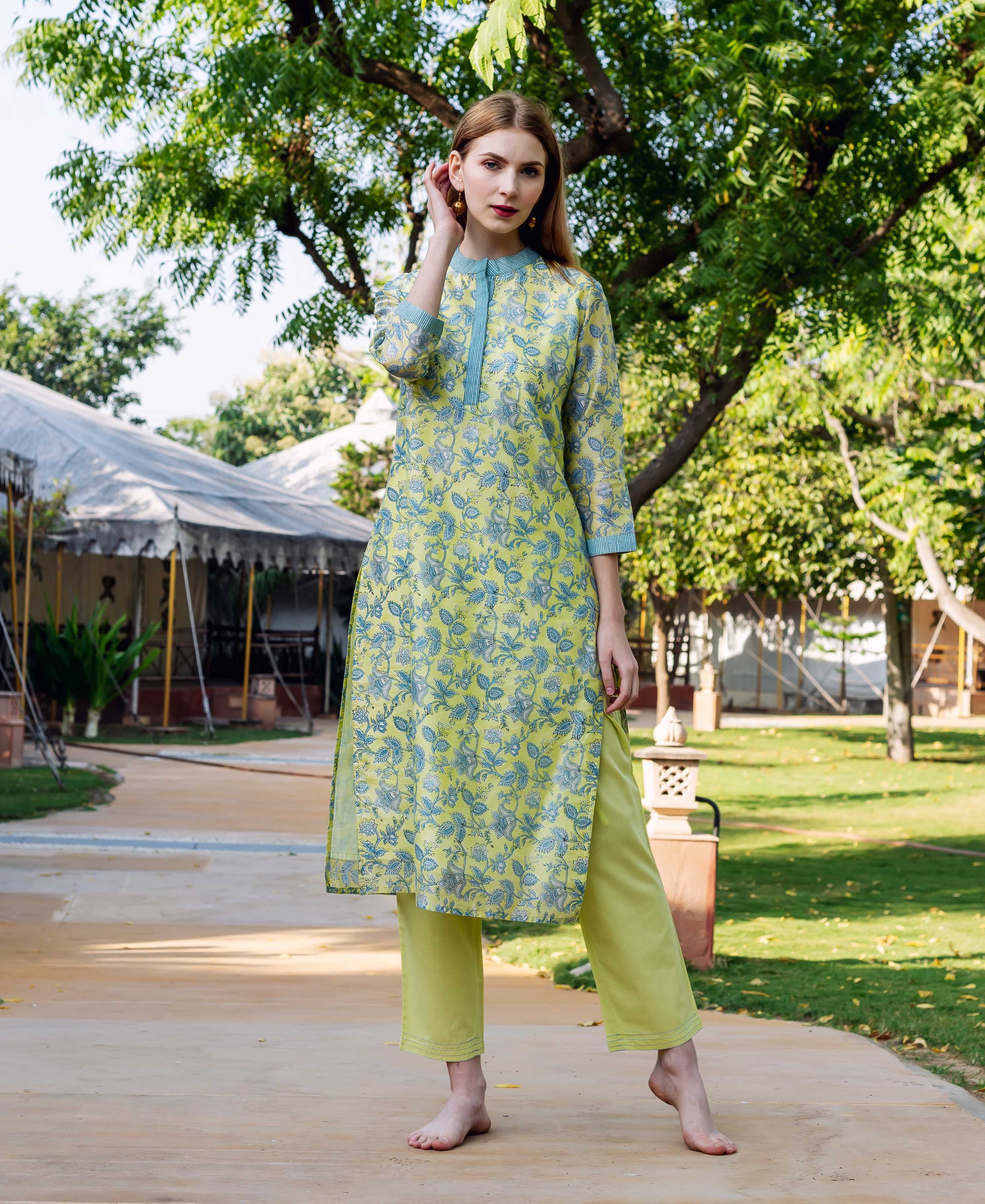 Front full look of model wearing green hand-block printed floral kurta and matching straight pants.