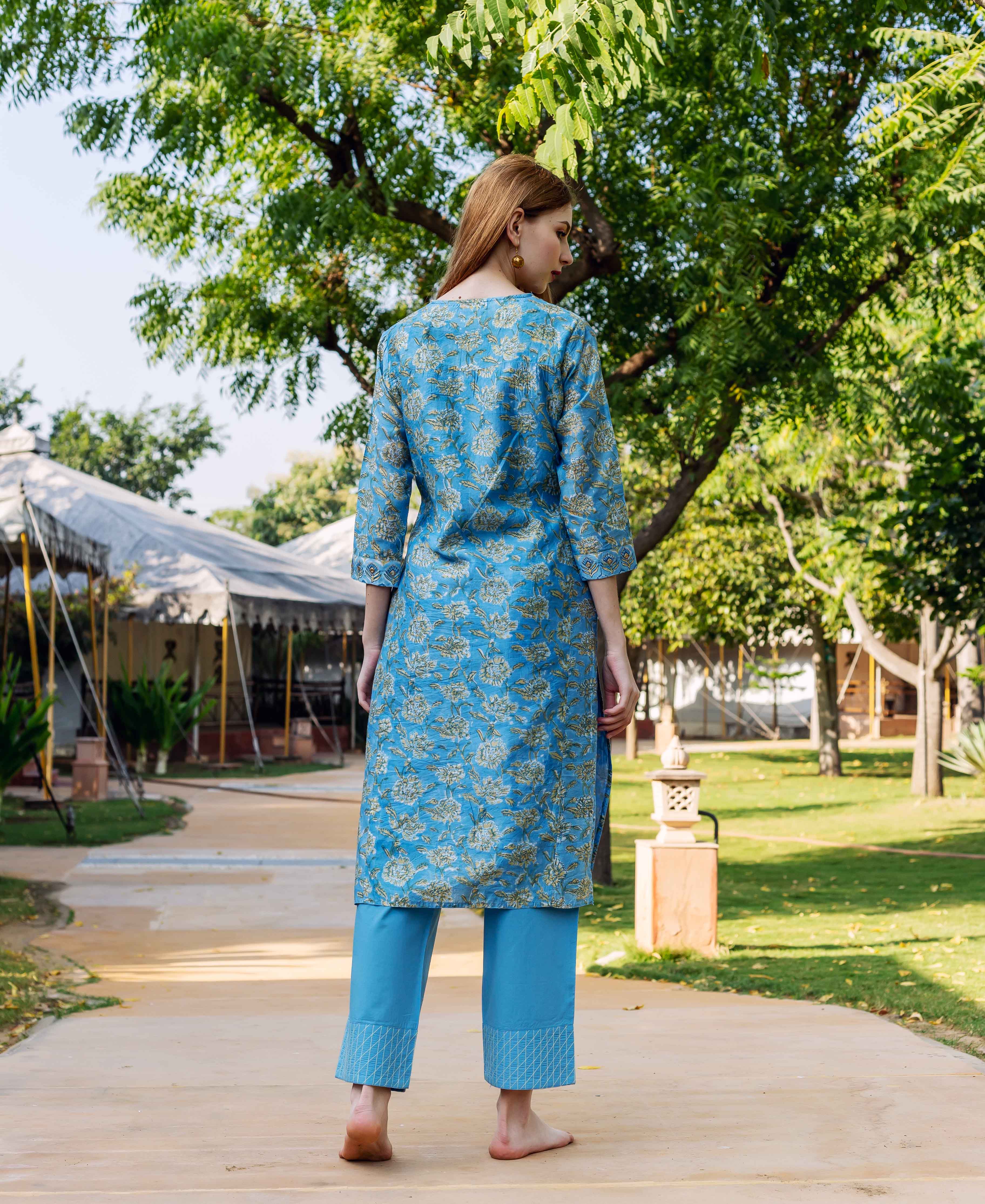 Model from back wearing blue hand-block-printed floral kurta and matching straight pants.