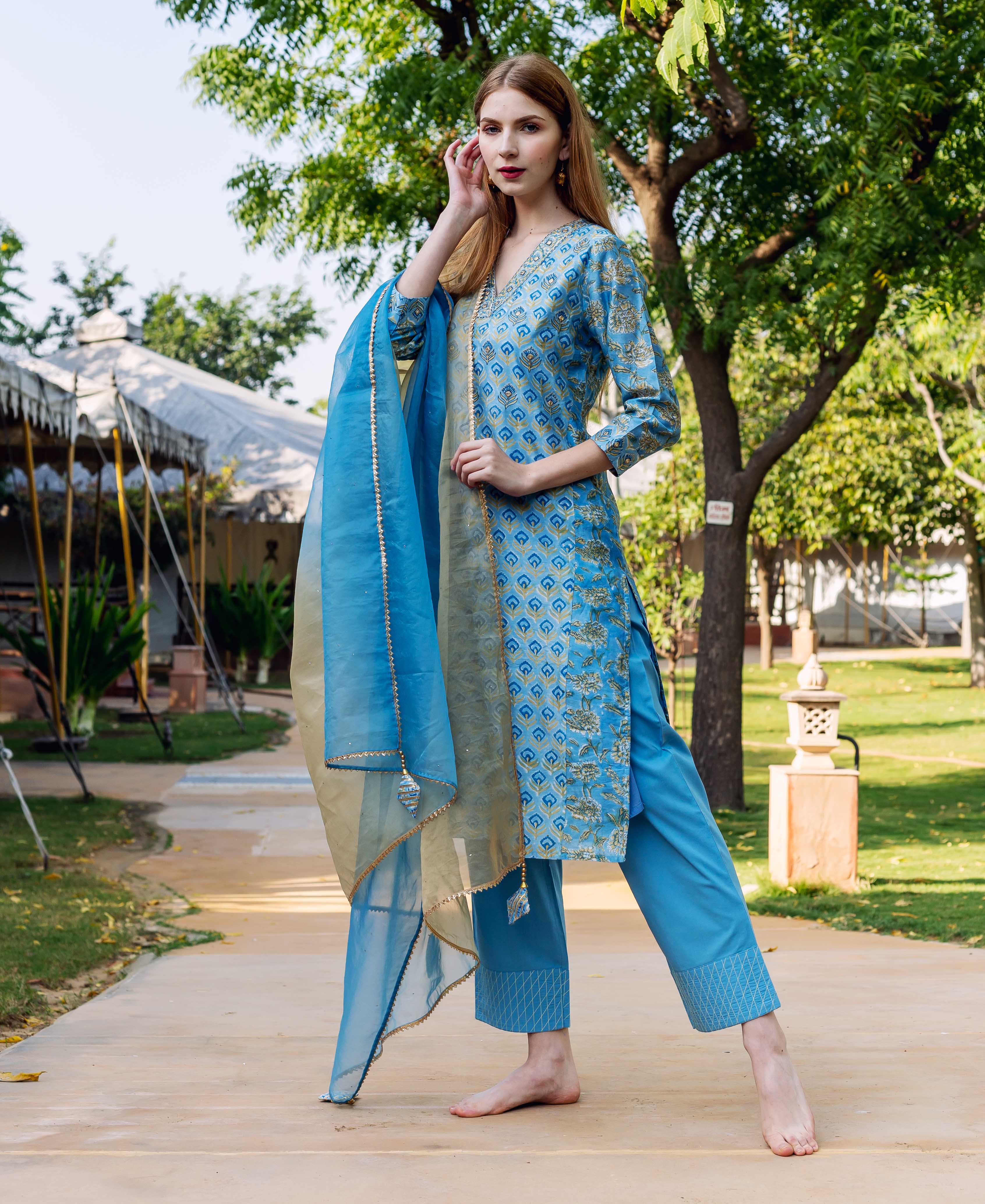 Blue and gold hand-block-printed straight kurta on model with matching pants and dupatta.