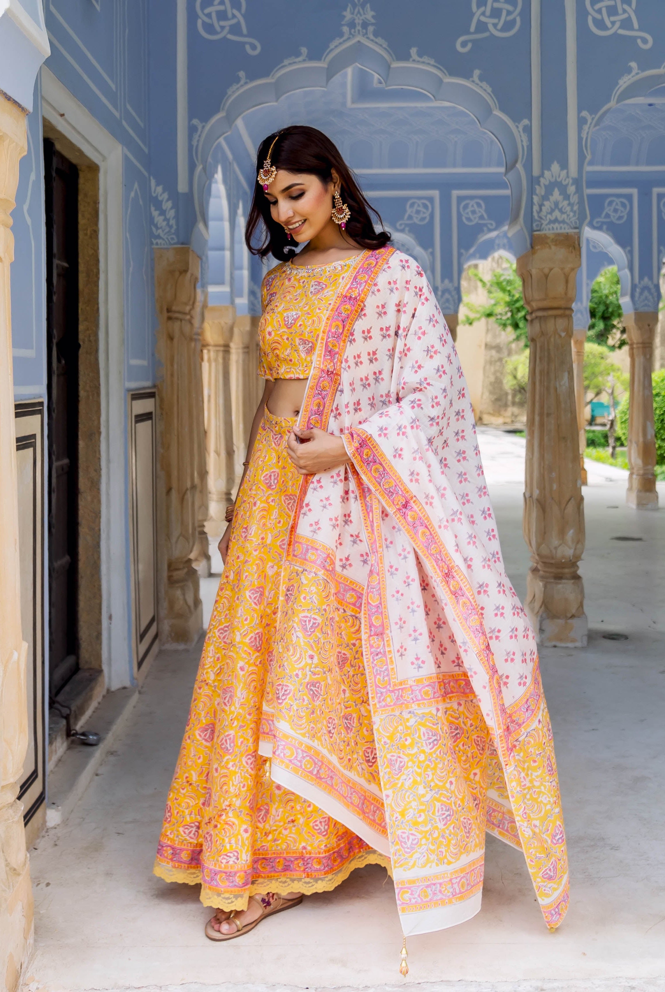 Full look of model in yellow and white hand block printed lehenga set.