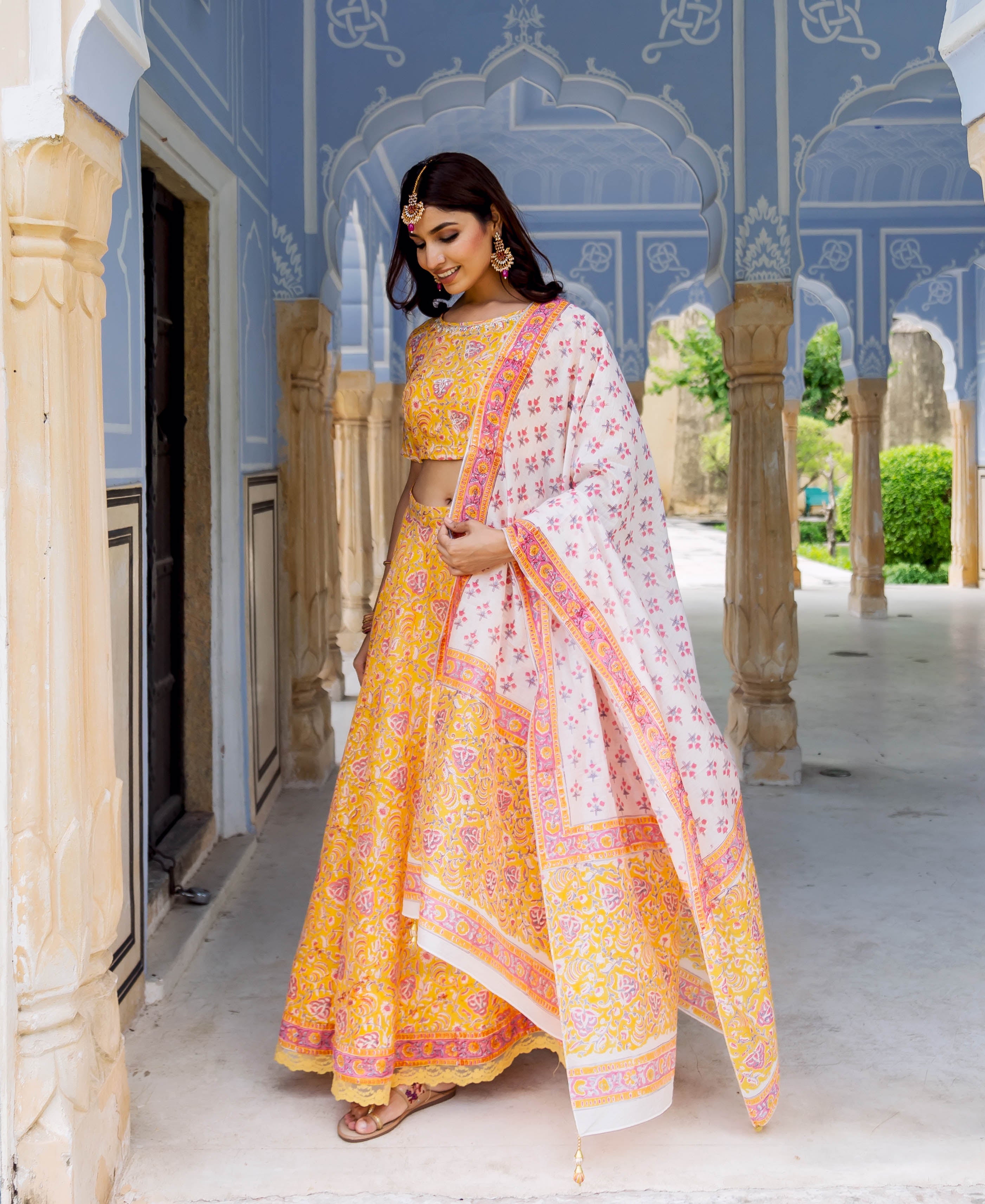 Full look of model in yellow and white hand block printed lehenga set.