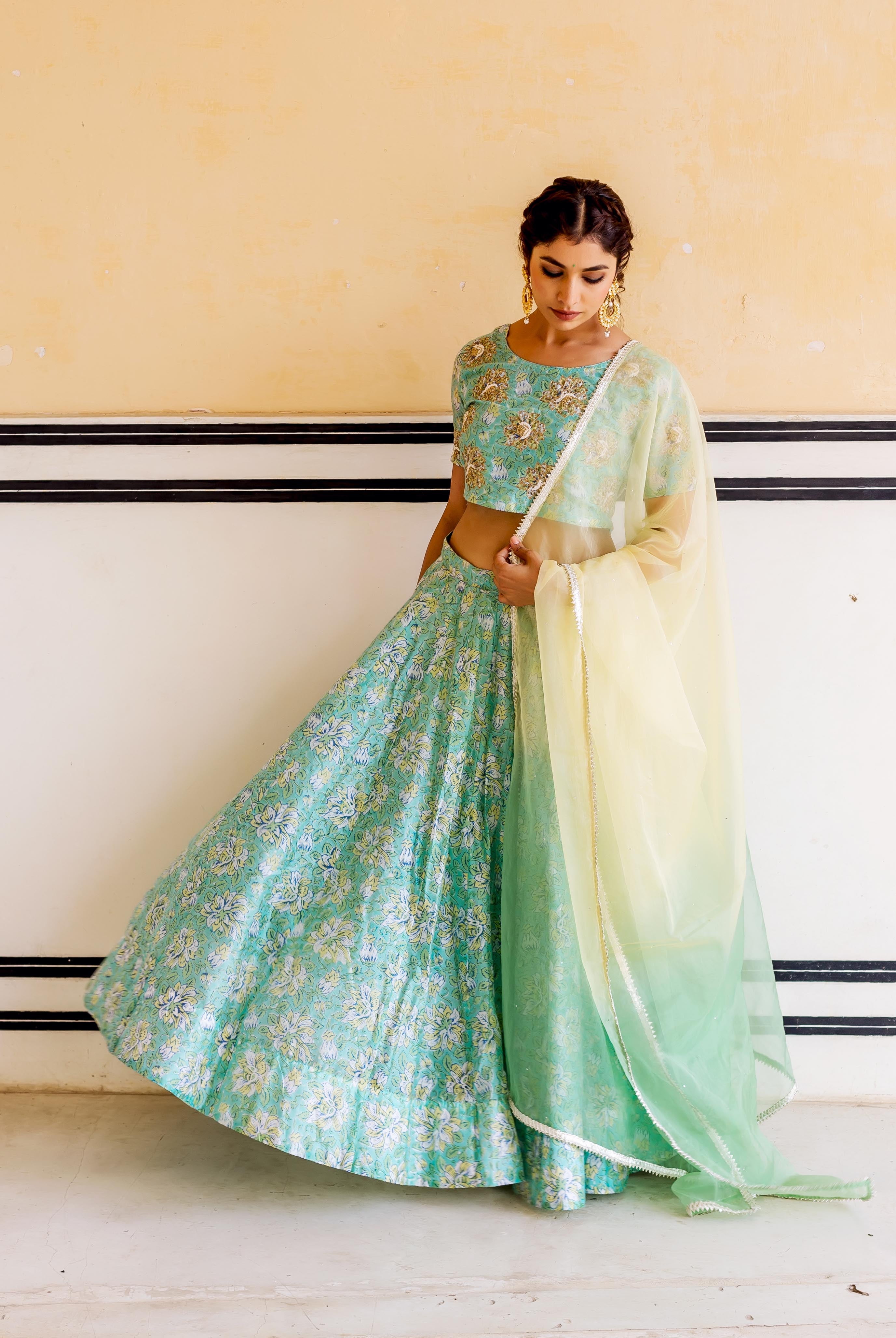 Green and gold hand-block-printed lehenga set with embroidery and sheer yellow ombre dupatta.