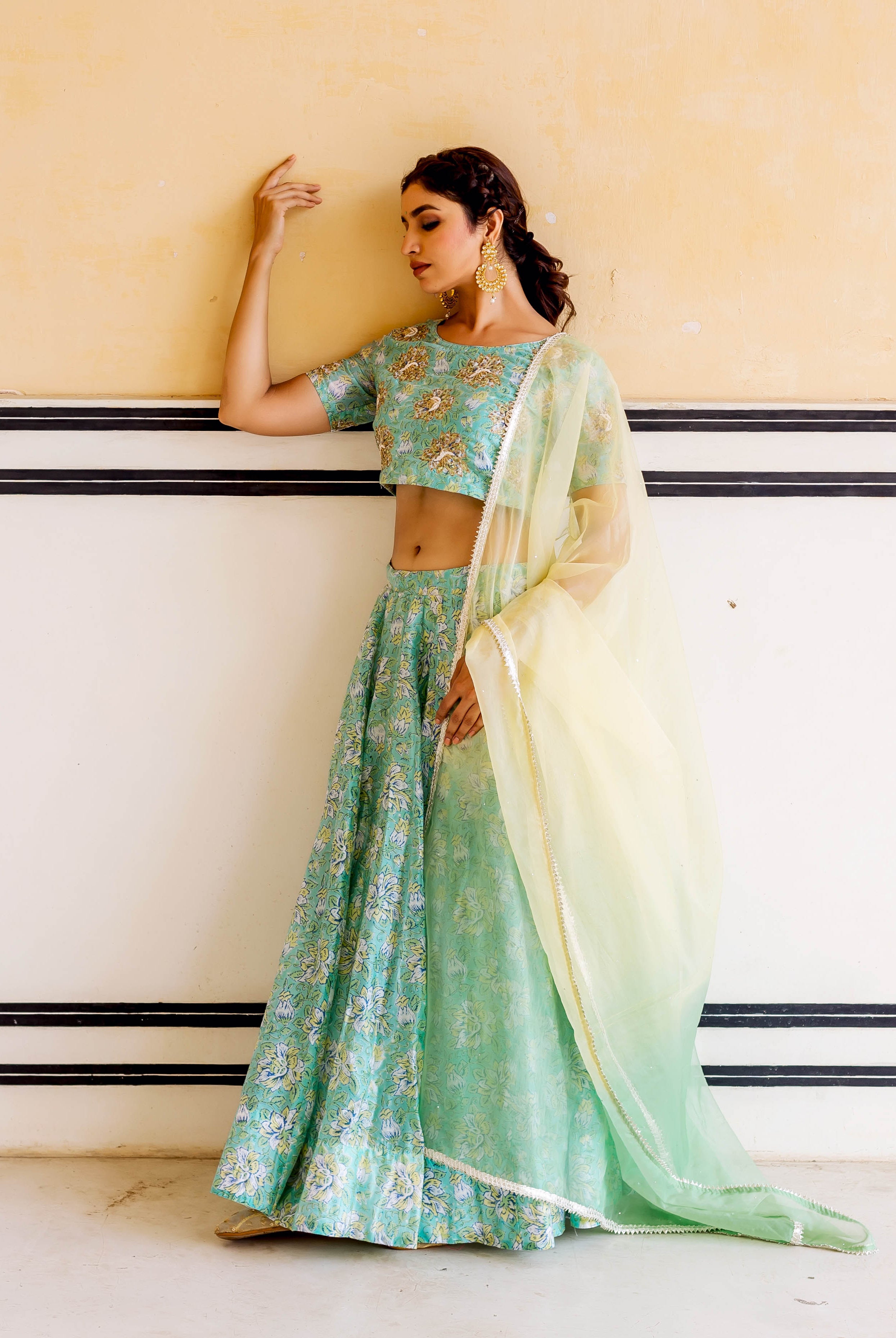 Full shot of model in Mehar green hand block printed and embroidered lehenga set.