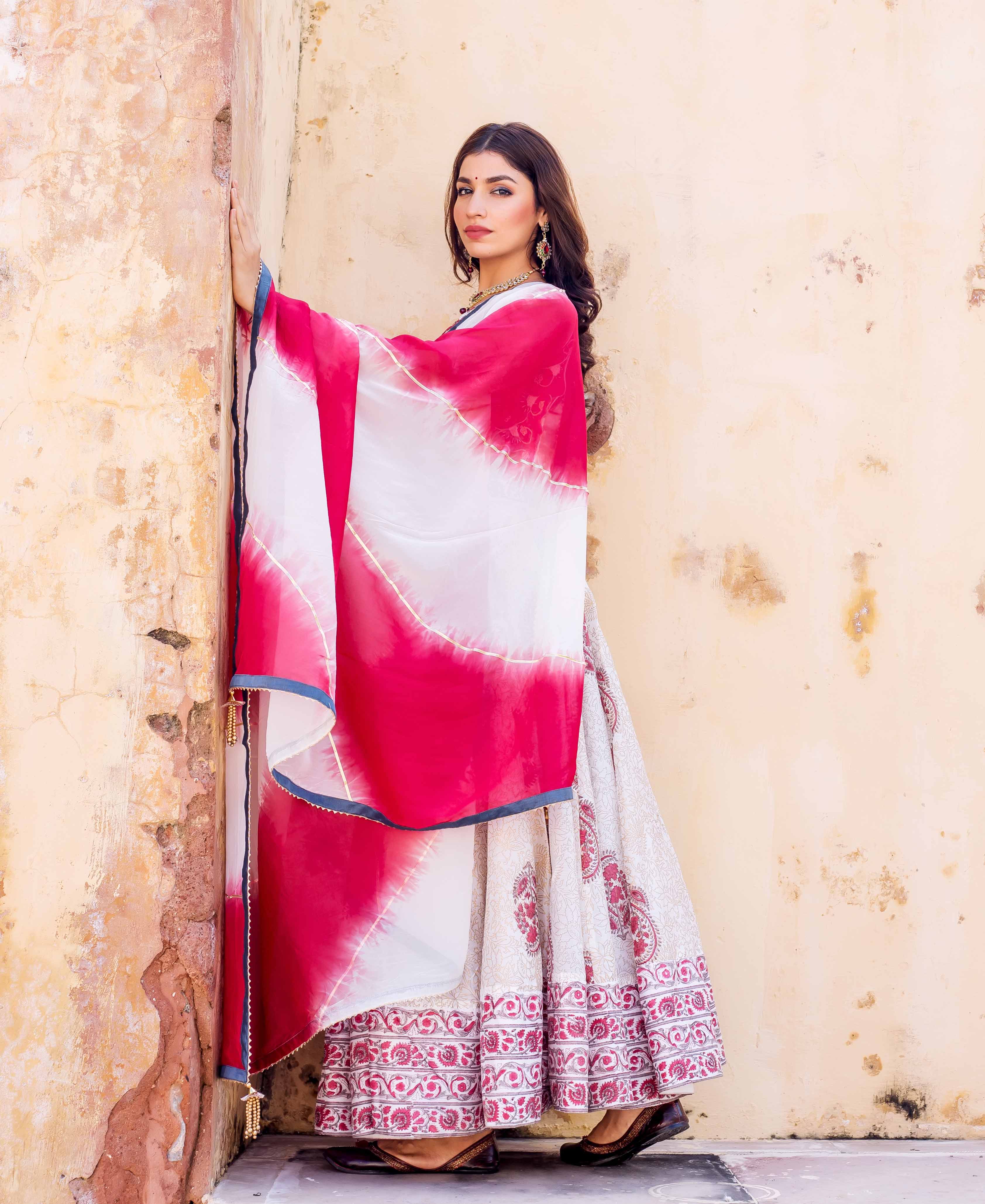 Model in full-length Zoya hand-block printed lehenga with vibrant pink-white bandhani dupatta.