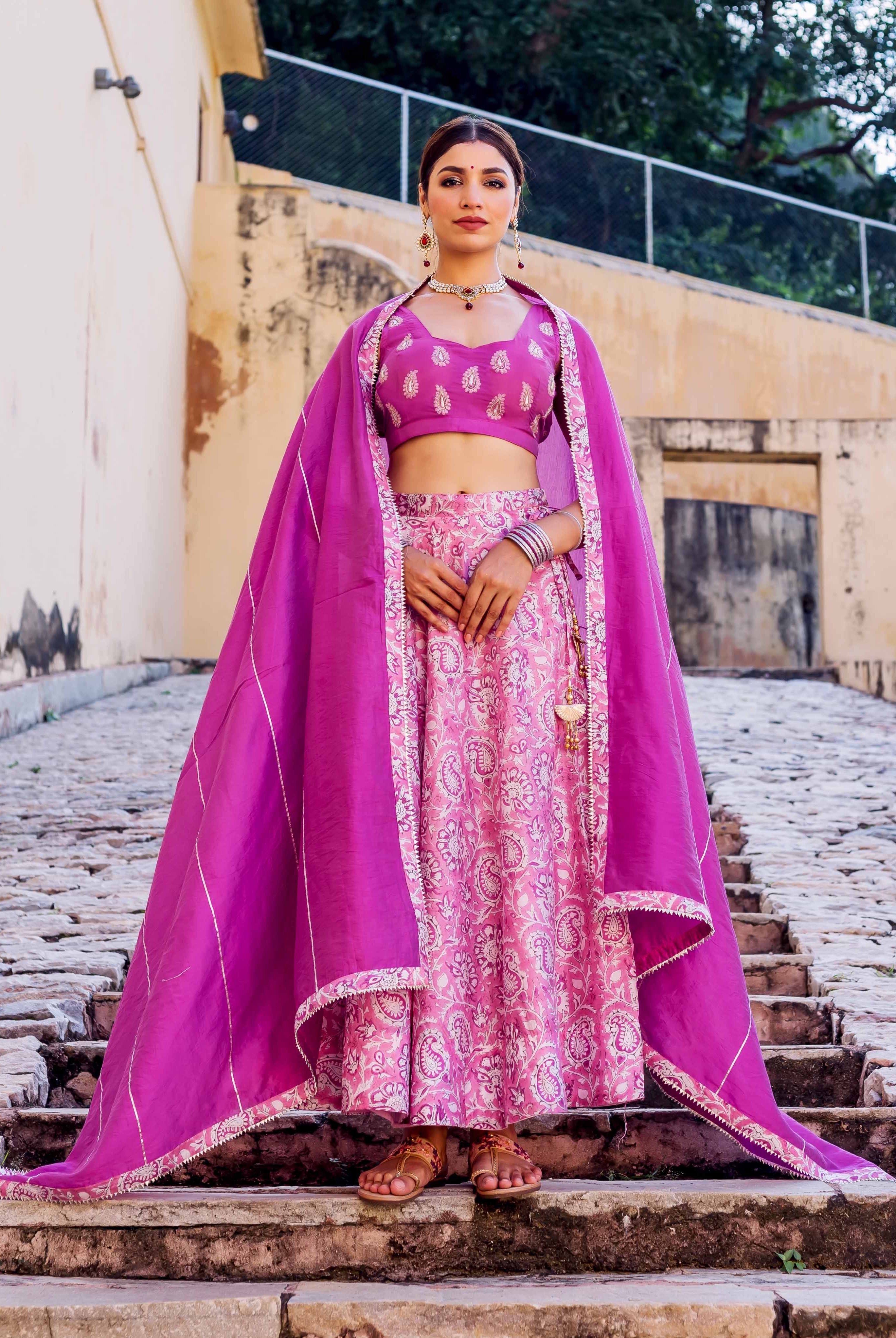 Full look of model in a pink and purple hand block printed lehenga set.