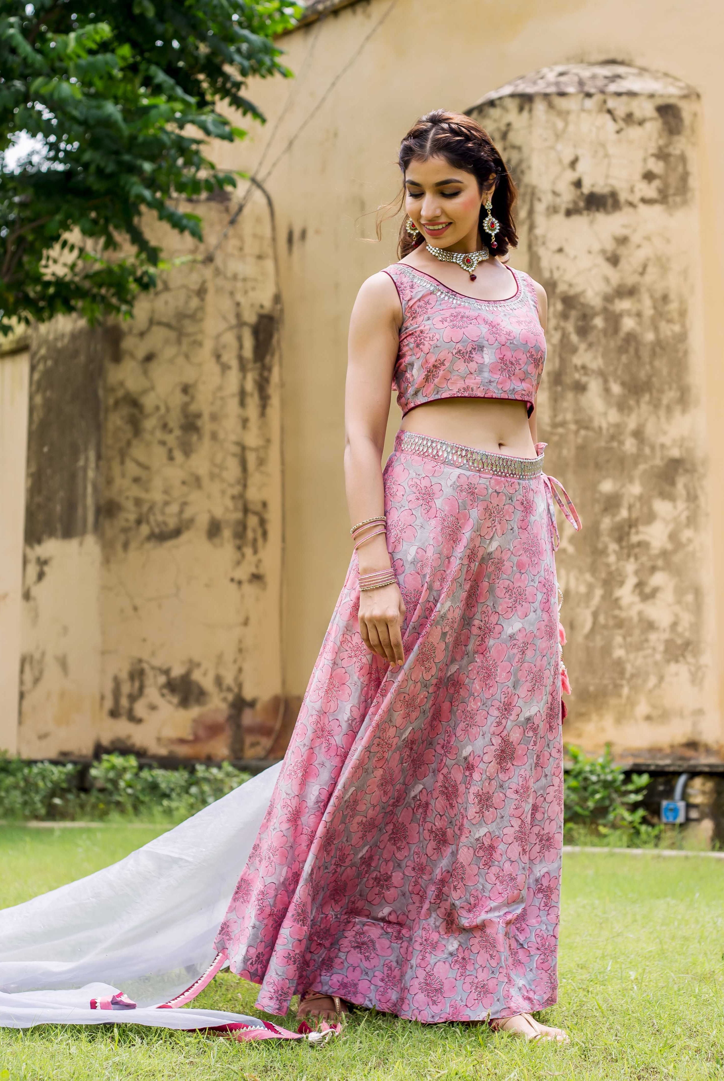 Front full look of model in pink and grey hand block printed lehenga set.