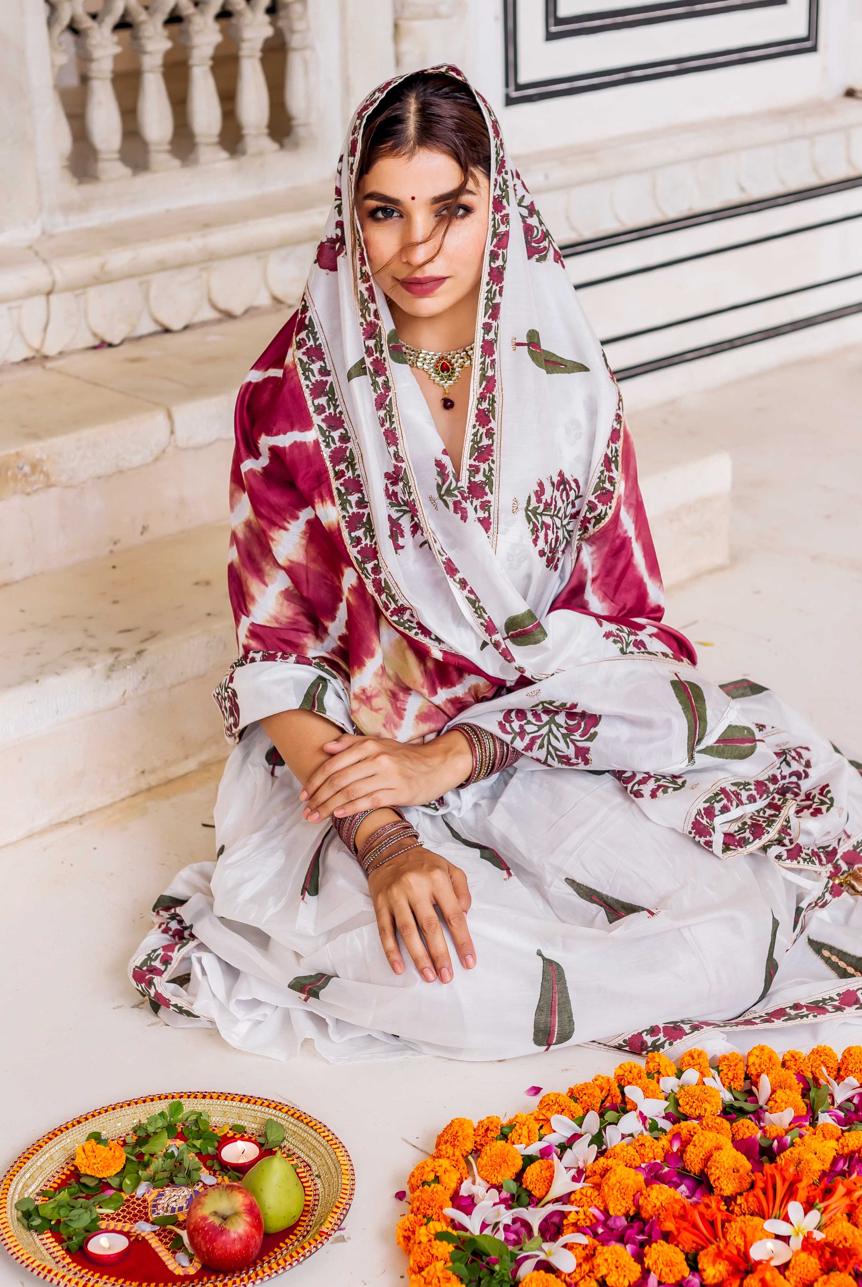 Model seated wearing a white and maroon MISSPRINT hand-block-printed lehenga set.