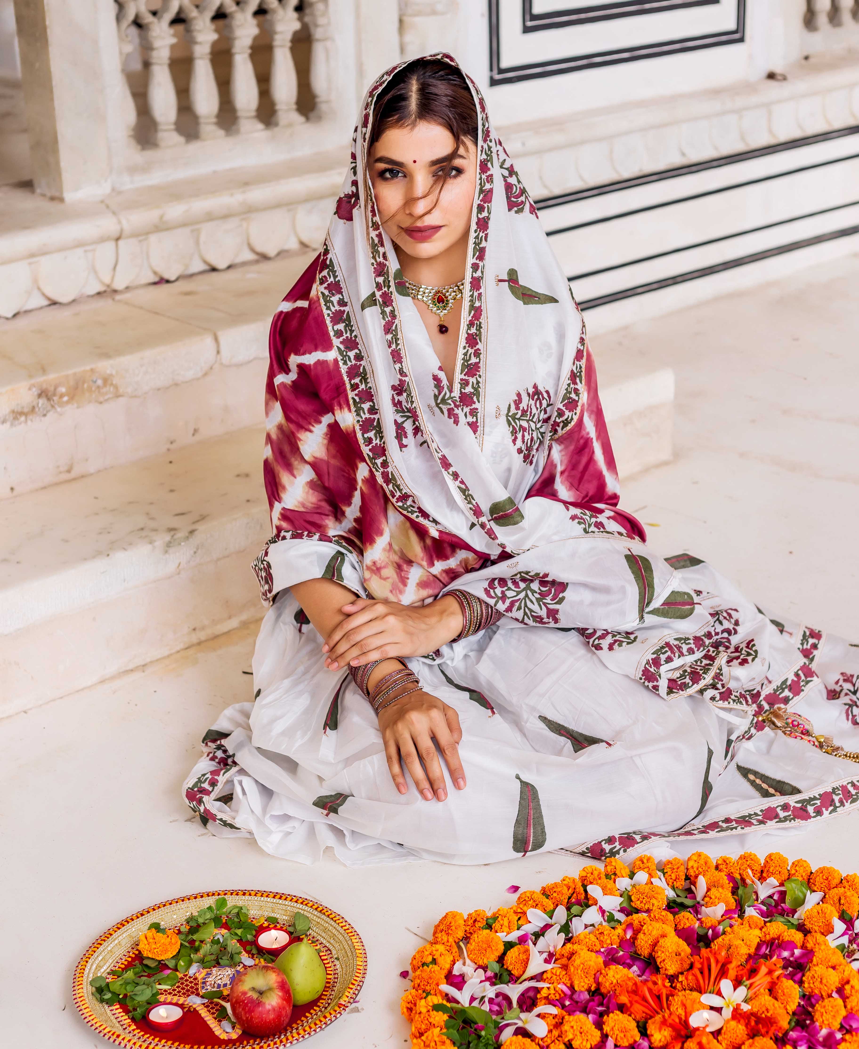 Model seated wearing a white and maroon MISSPRINT hand-block-printed lehenga set.