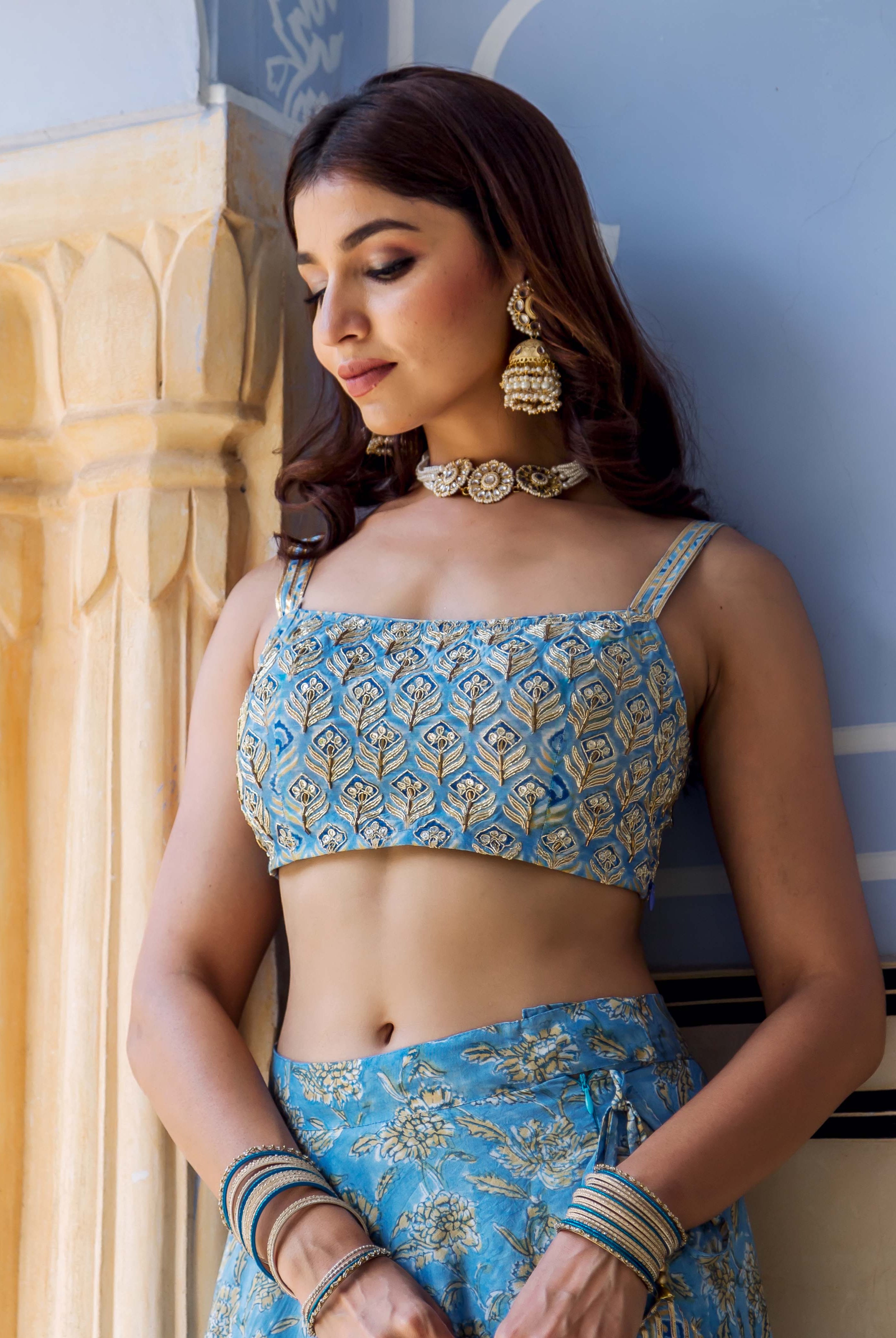 Model in blue hand-block-printed and embroidered crop top and floral skirt.