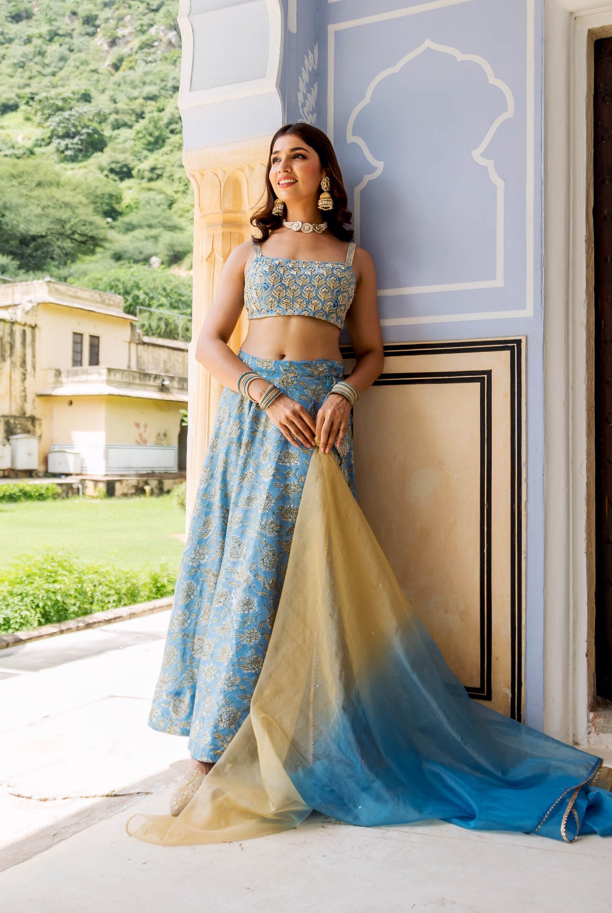Model in light blue embroidered hand-block-printed lehenga set with ombré dupatta.