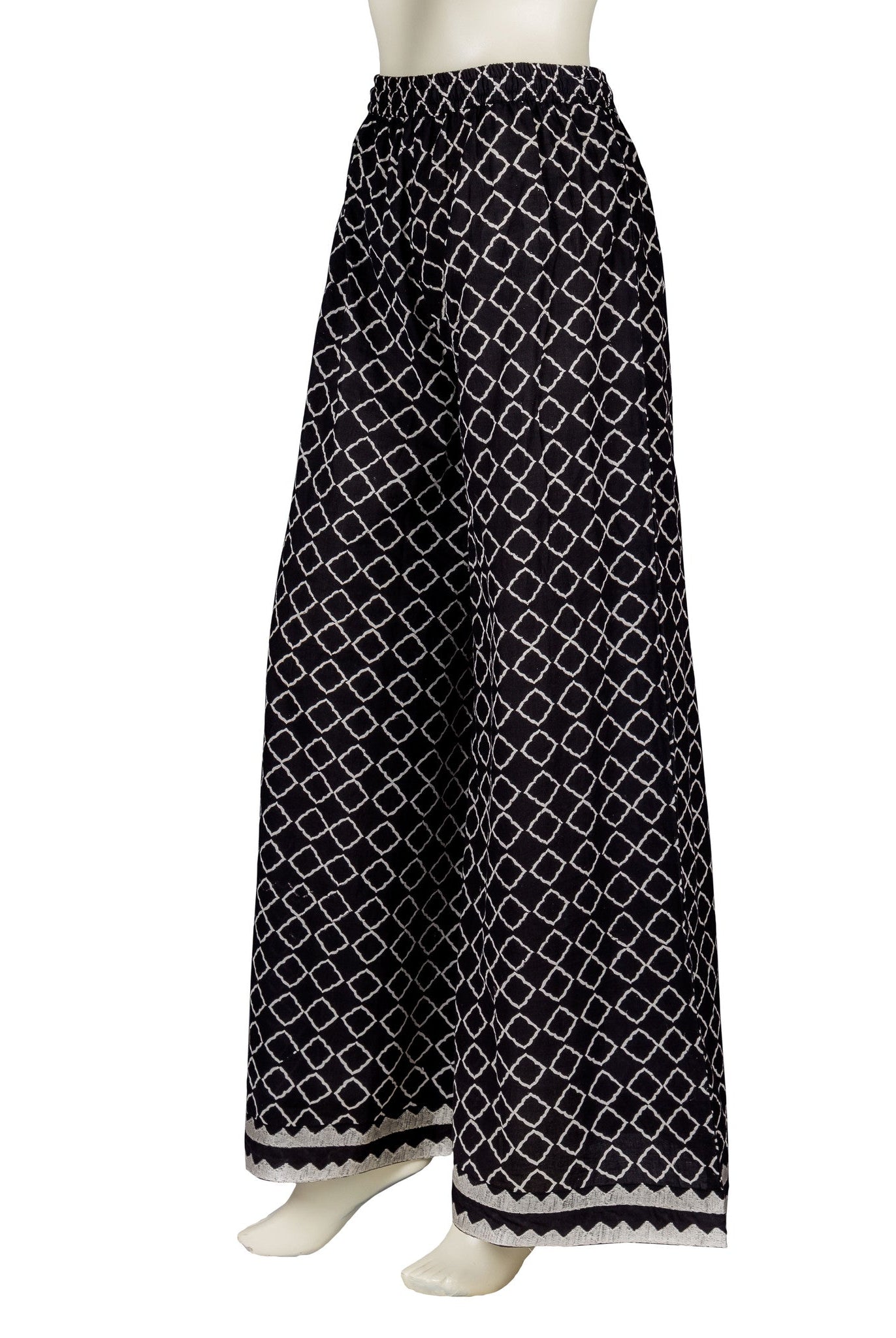 Side view of monochrome black and white block-printed wide-leg palazzo pants on a mannequin.