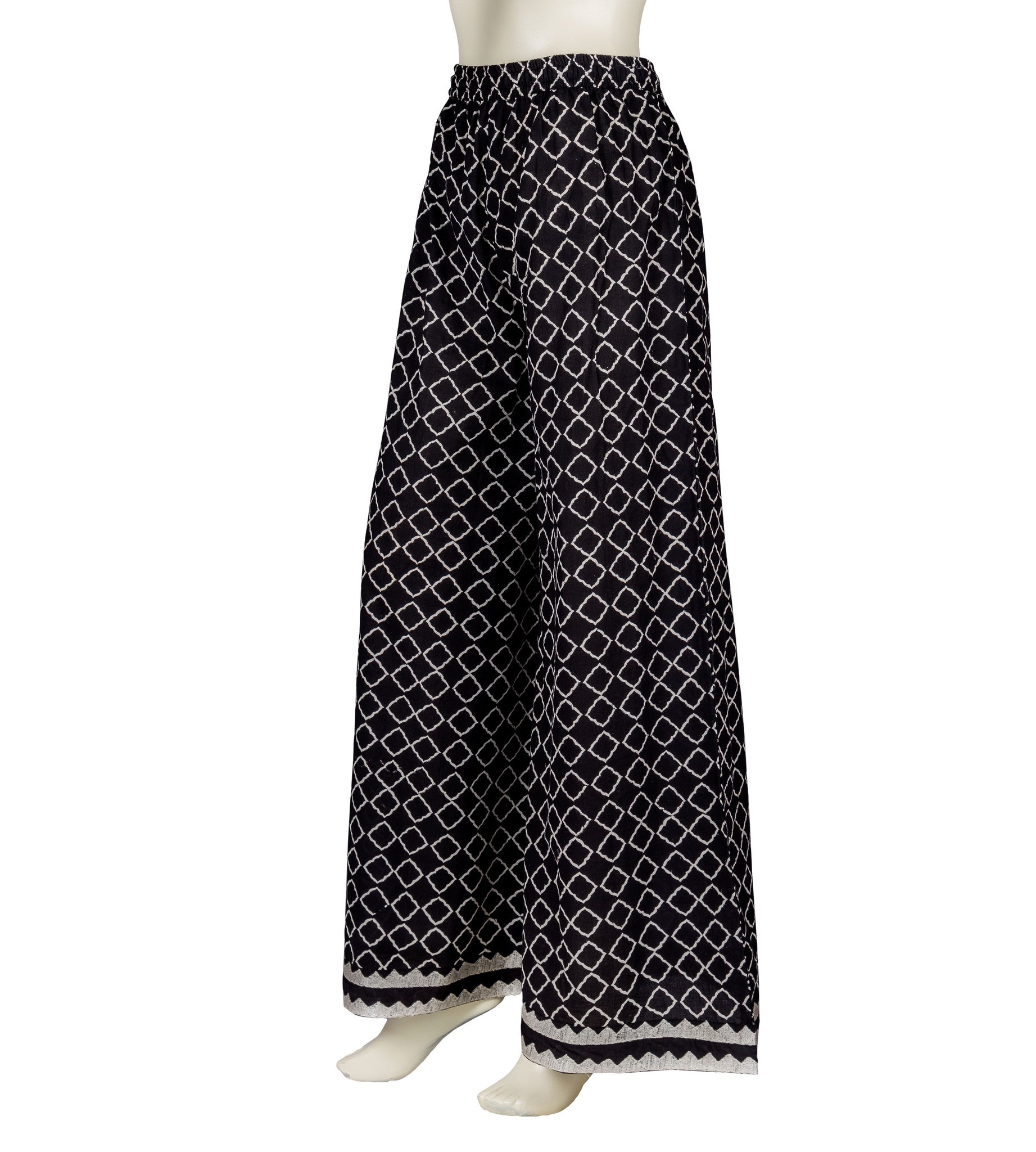Side view of monochrome black and white block-printed wide-leg palazzo pants on a mannequin.