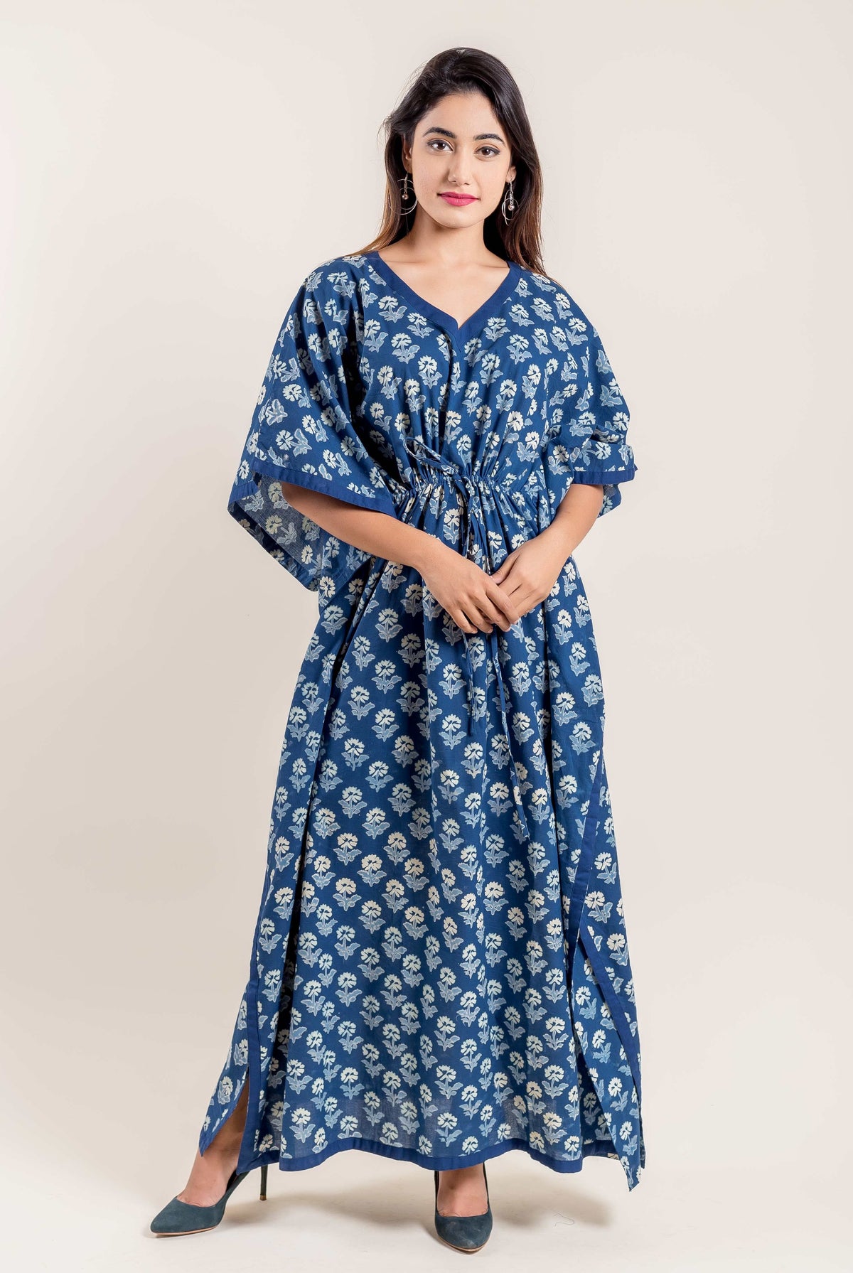 Full-length front view of model wearing indigo blue floral hand block printed V-neck kaftan.