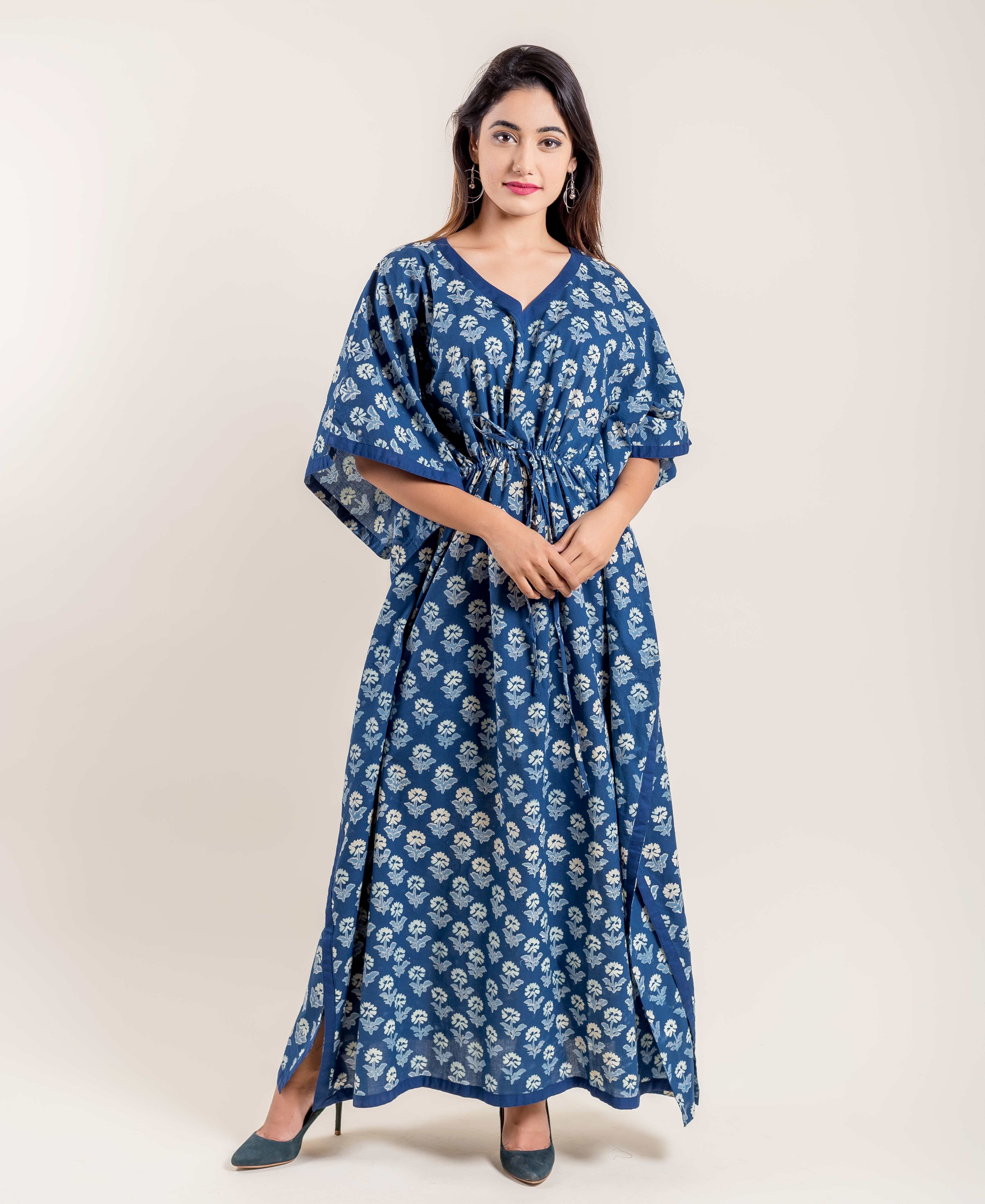 Full-length front view of model wearing indigo blue floral hand block printed V-neck kaftan.