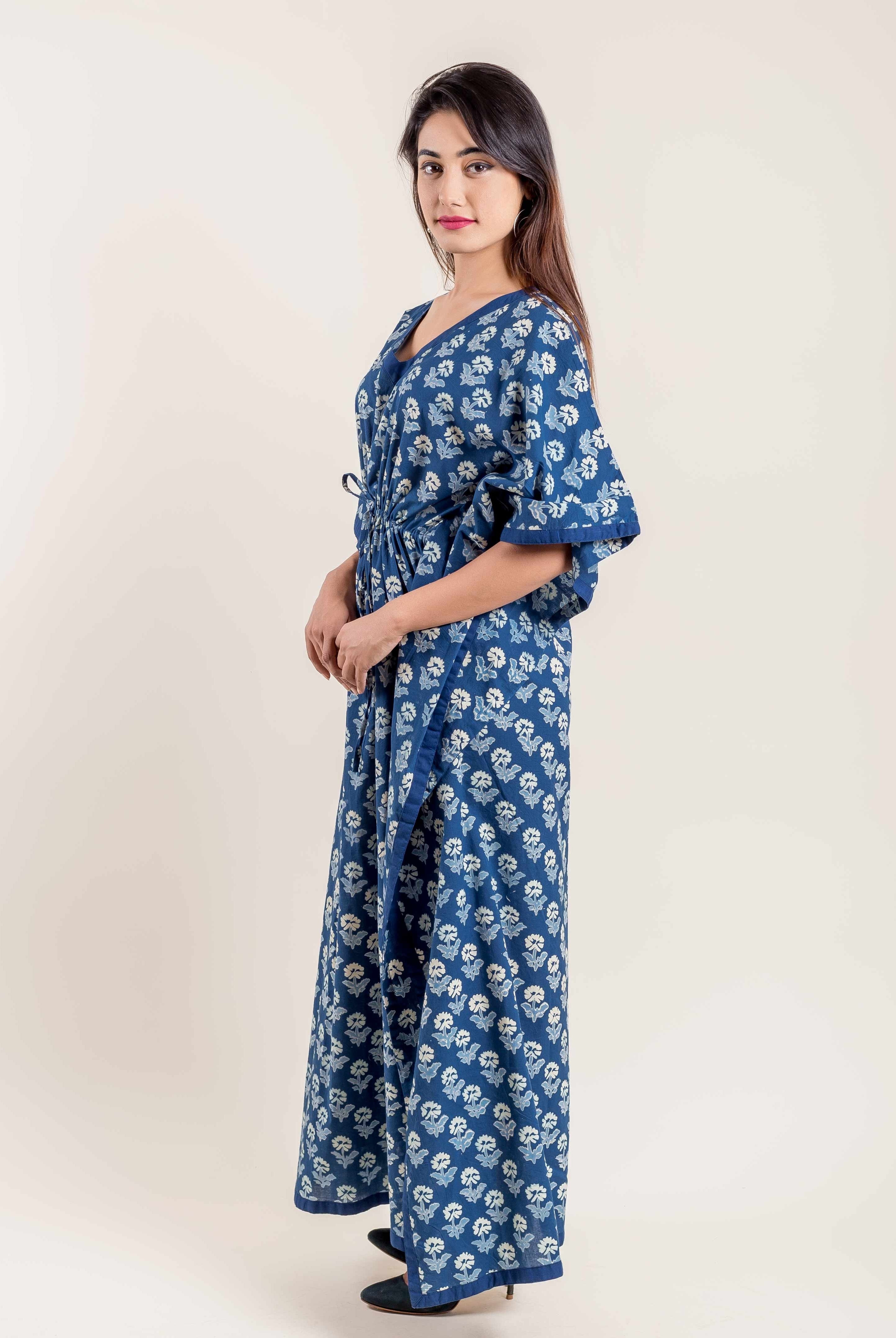 Woman modeling a full-length indigo blue floral hand block printed kaftan, three-quarter view.