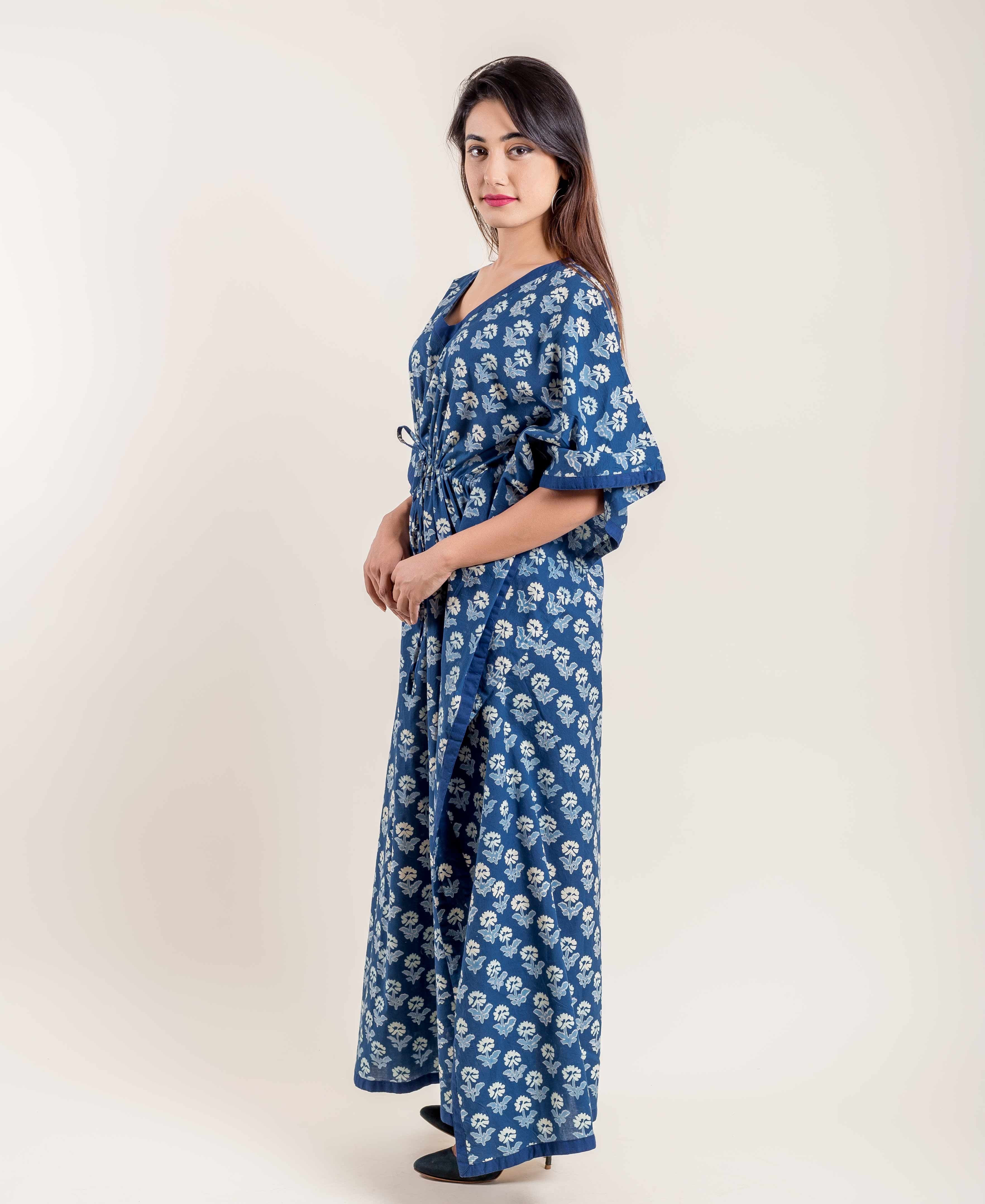 Woman modeling a full-length indigo blue floral hand block printed kaftan, three-quarter view.
