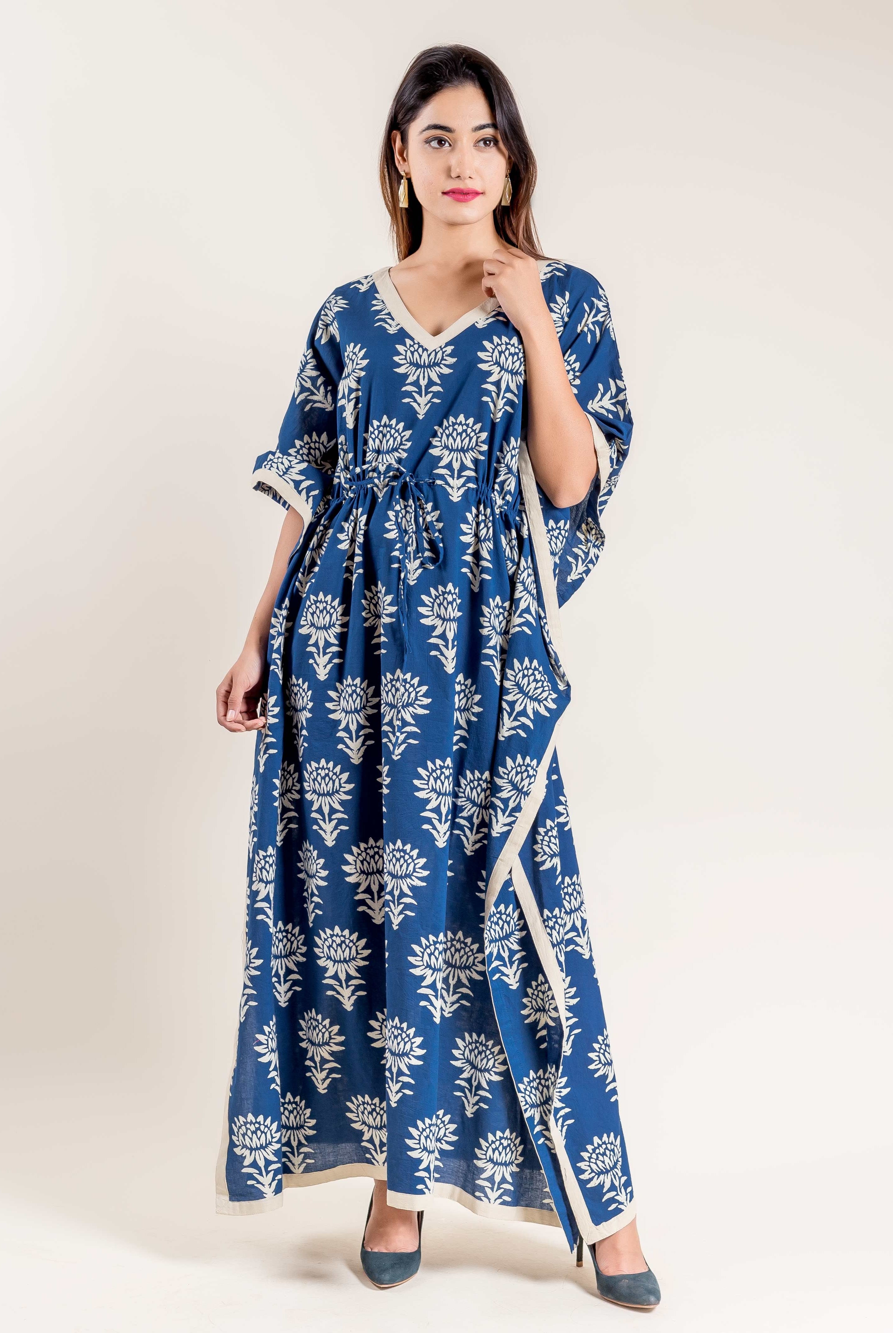 Front view of a model wearing an indigo blue floral hand block printed tie-up kaftan.
