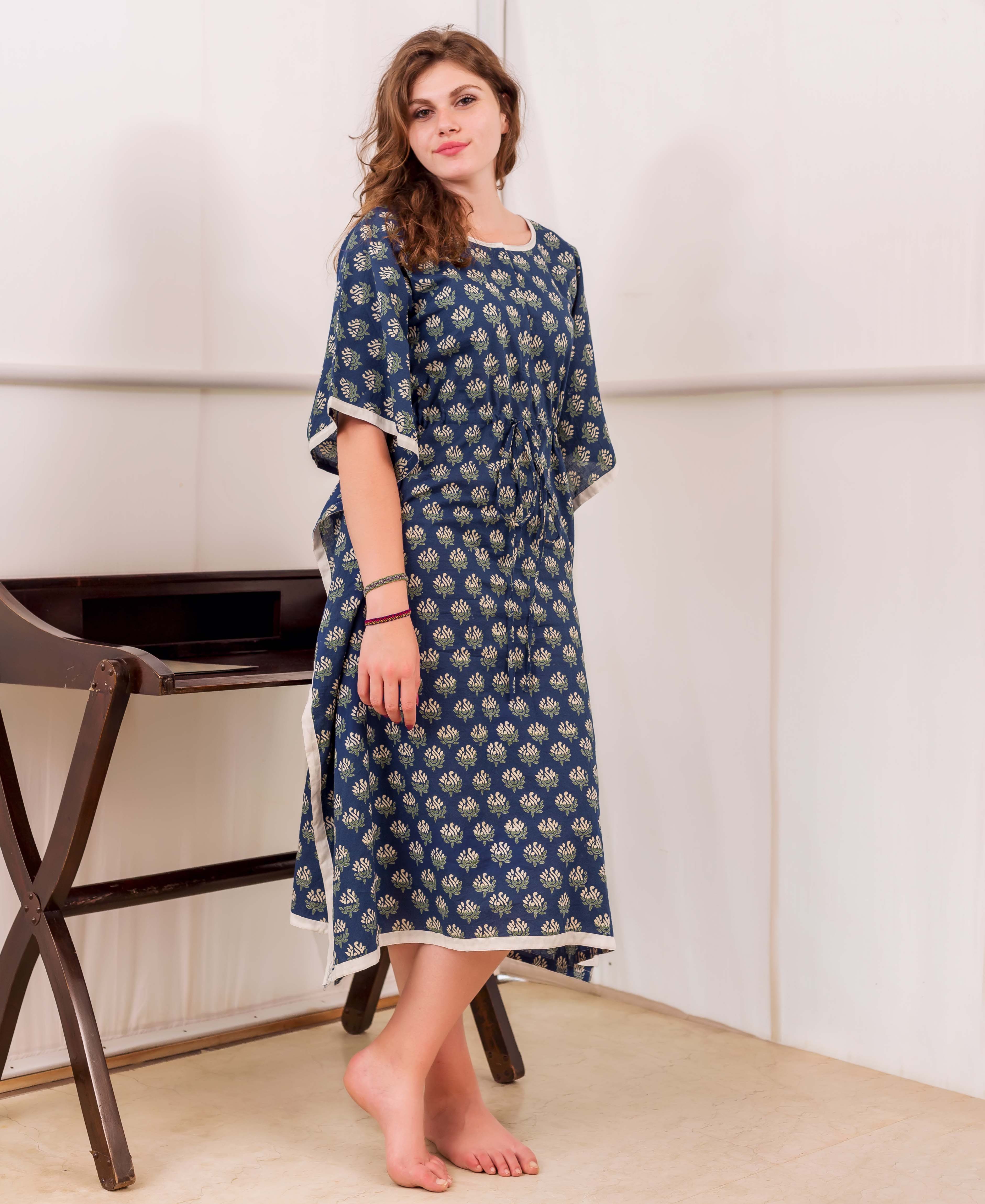 A woman wearing a blue and white block-printed kaftan with a floral pattern.