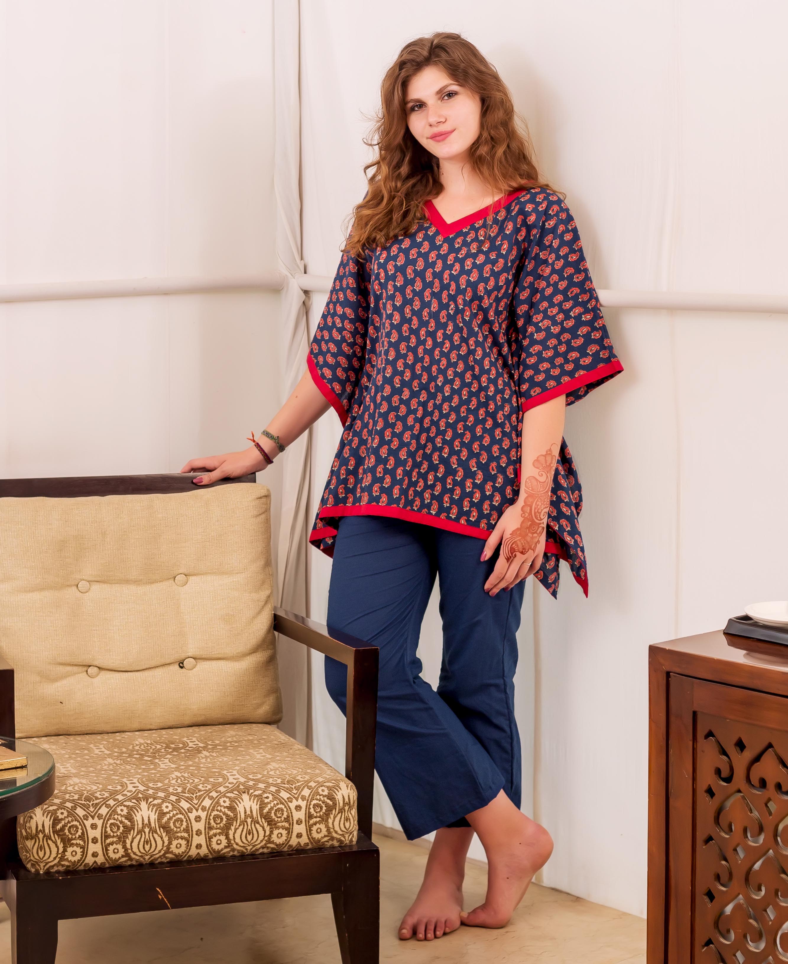 Indigo and red hand-block-printed kaftan top on woman, paired with solid blue pants.