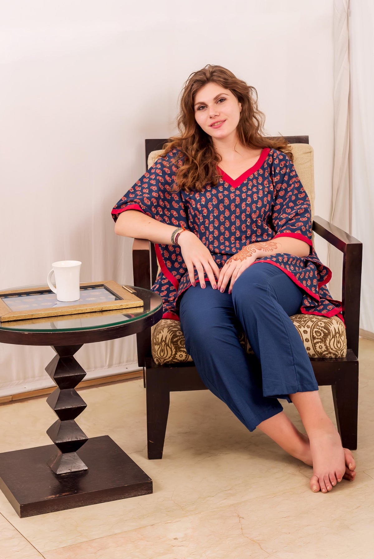 Front full look of a model wearing an indigo and red block-printed kaftan with blue pants.