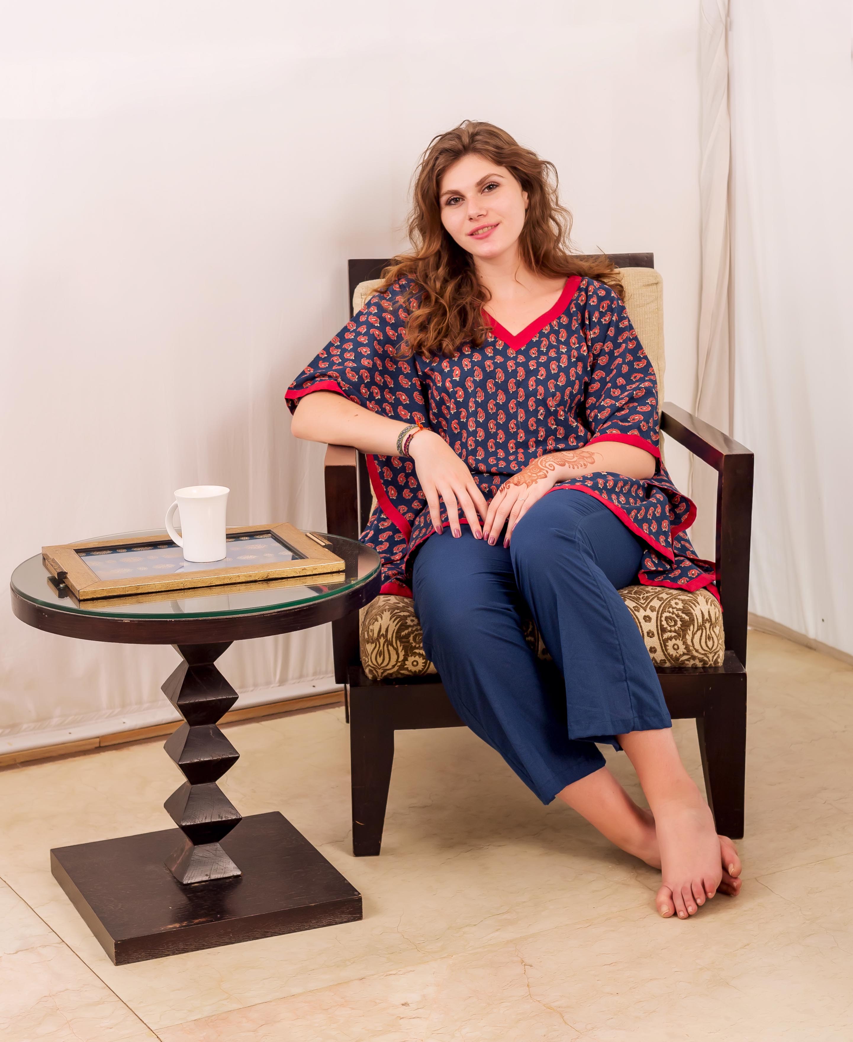 Front full look of a model wearing an indigo and red block-printed kaftan with blue pants.
