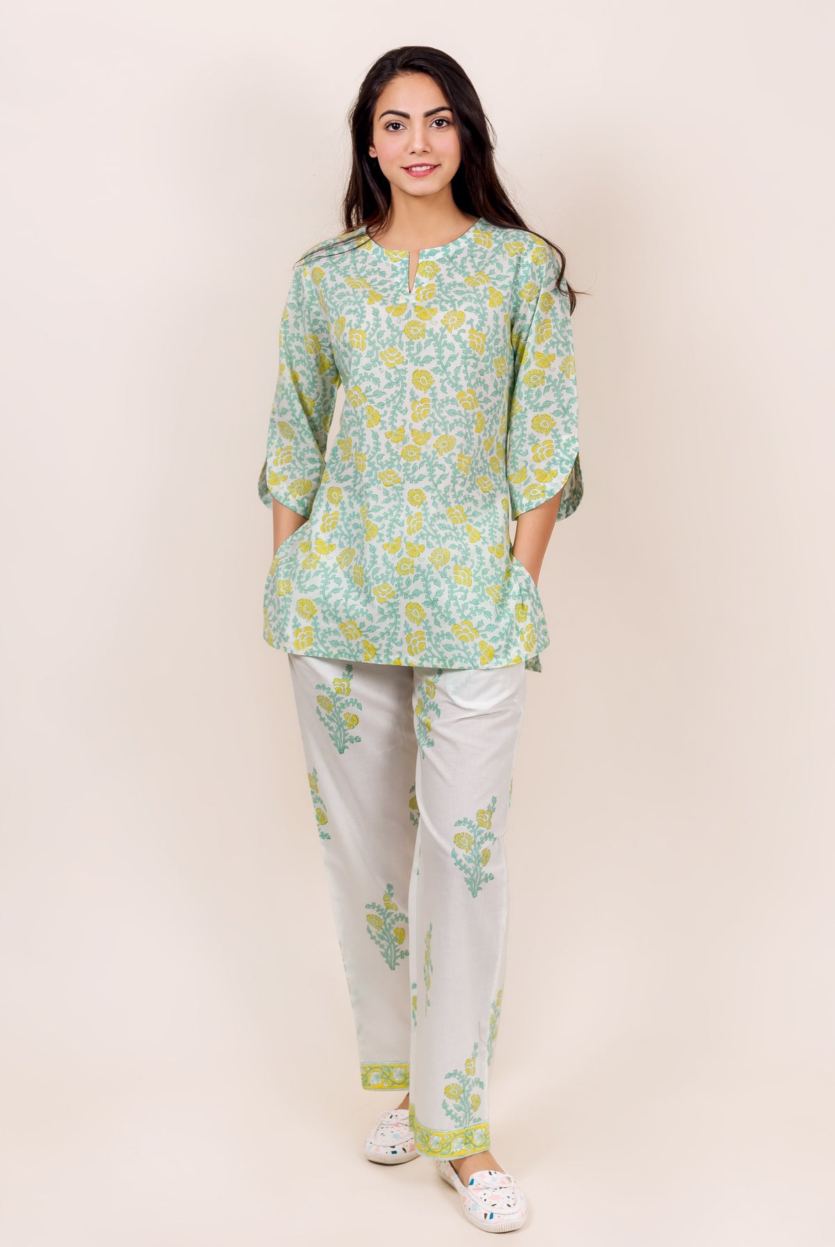 Front view model in green, yellow, and white floral block printed top and pajama set.