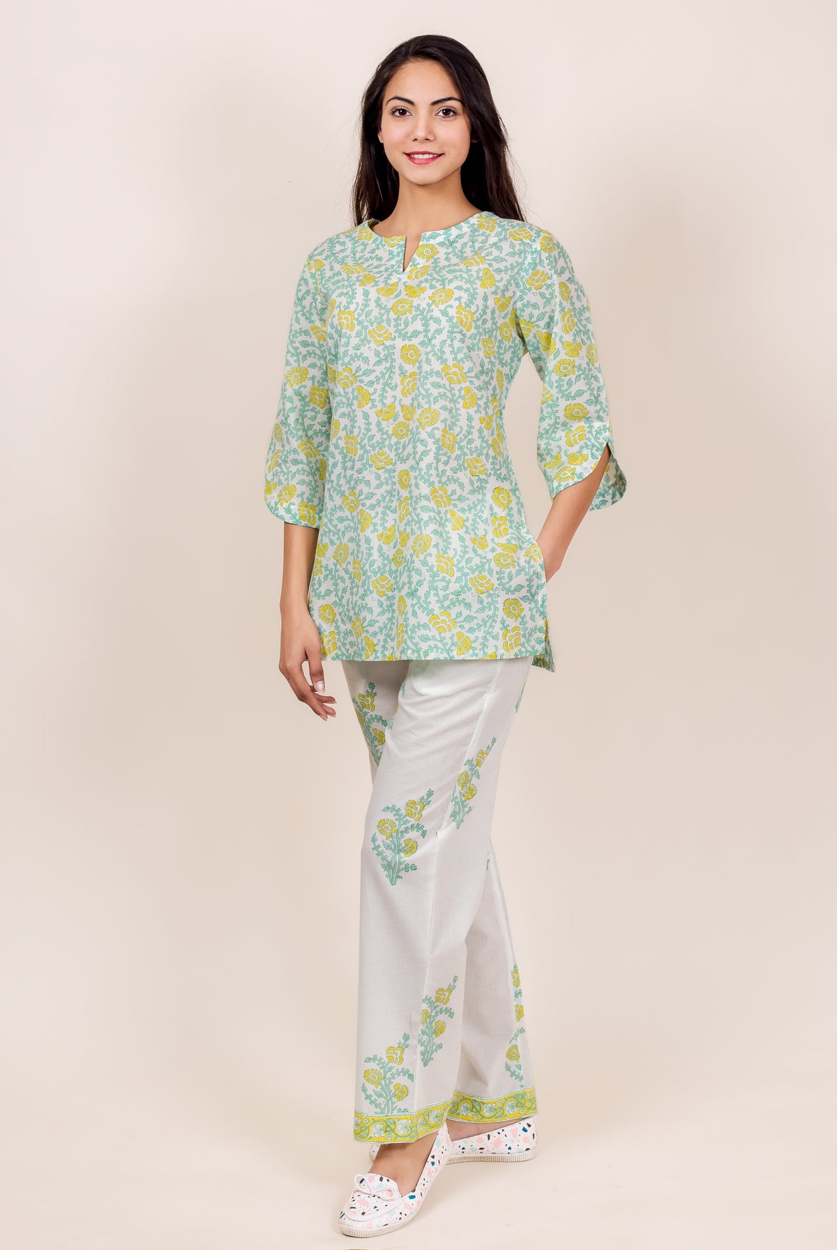 Front view of model in light green and white floral block print top and pajama.