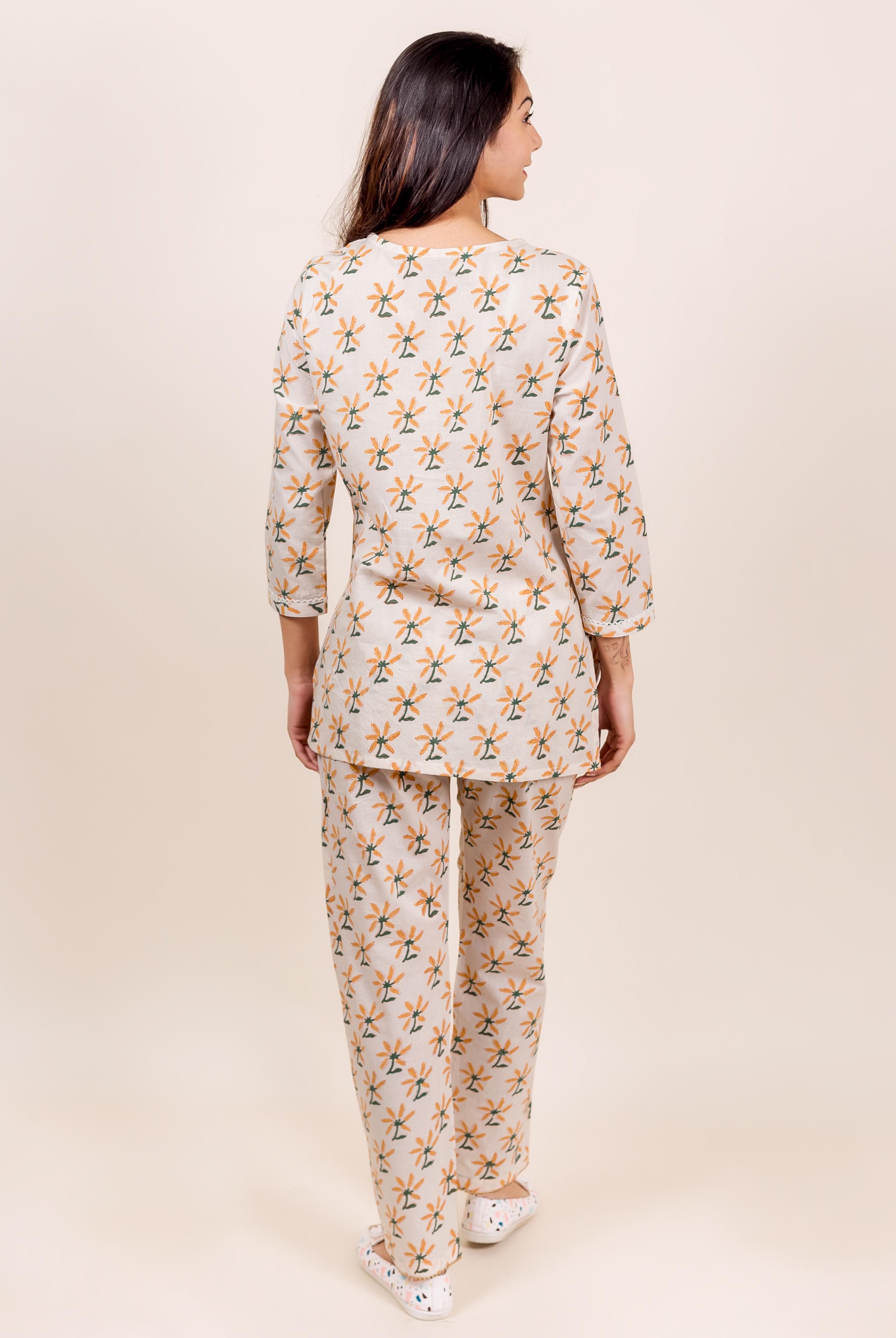 Beige block-printed top and pajama on a model, back view, floral print.