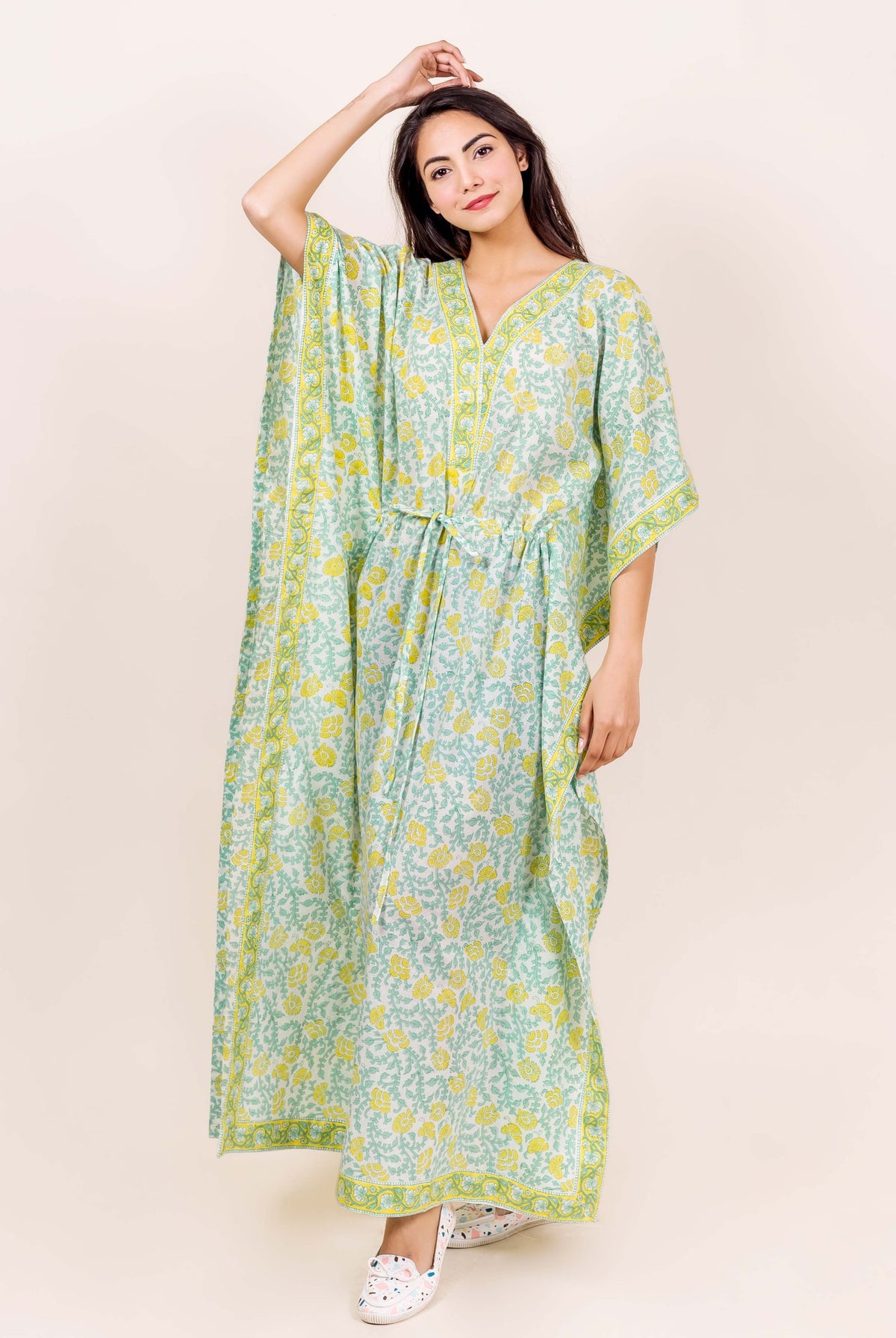 Model in full-length mint green and yellow floral block printed kaftan loungewear.