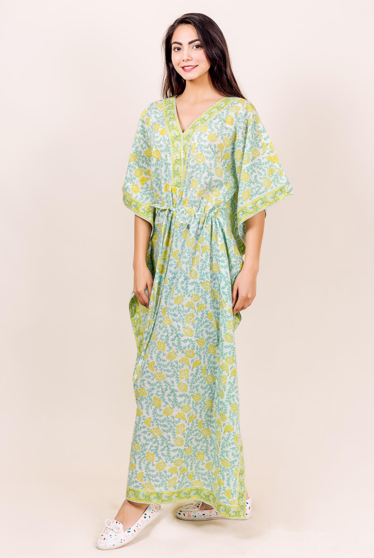 Front view of model in full-length light green and yellow floral block printed kaftan lounge wear.